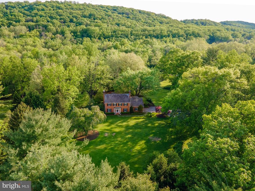 Live authentically. A river runs through it. Extraordinary opportunity to sculpt your vision for living in an enduring Greenspring Valley locale. Sublime 8.42 acre gently rolling estate lot with ample building envelope to expand the existing well cared for house at the end of a long meandering drive. Relish the visual and auditory sensations as the Jones Falls River and multiple tributaries converge in your very own yard. The possibilities for framing vistas and long views of river banks abound. Once in a lifetime site, beckoning a strong architectural vision. The setting calls for a forward thinking contemporary, where less is more. Ponder the benefits of building exactly what you want. Experience the satisfaction of the ultimate gathering and cooking spaces punctuated with your own style. A fluid floorplan with first floor owner suite invites an abundance of natural light and seamless indoor outdoor connections. How could a floorplan streamline your daily routine? How could inspiring outdoor spaces elevate your everyday? Could a sumptuous slumbering space and hyper organized dressing room have you feeling more refreshed? How much impact can a deluxe mudroom or pantry have on your life? Can being 5 to 10 minutes from everywhere you want to be give you time to engage in joyful pursuits? Does your current abode enhance your quality of life? Let us help you align forces with Delbert Adams Construction Group. Purpose-driven and thoughtful design with a focus on enduring beauty and sustainability. Unleash your imagination and build with the very materials you've been drawn to. It's time for change. Legacy setting. Estate lot in universally desirable location. Depending on your aesthetic and vision the house has much potential. Cultivate your existence. Book a field trip today. The art of uniting human and home. Do not go on property without an appointment. Listing agent must accompany. Photos of glass and stone river house are concepts for inspiration.