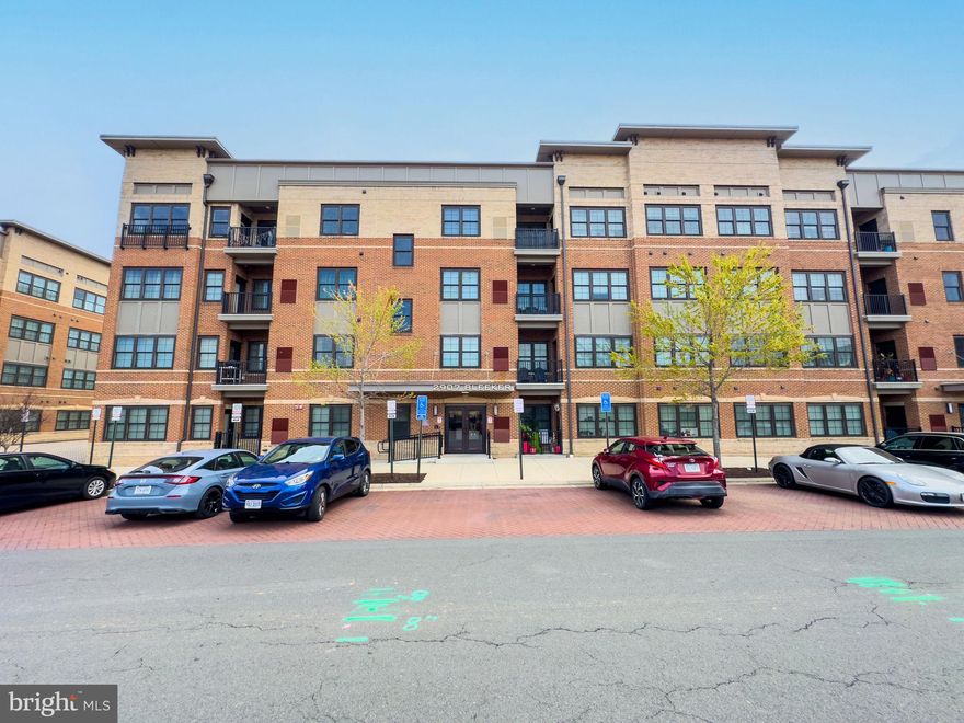 PARK IN FRONT OF 2907---AGENT CARD ON DASHBOARD. Location, location, location + Luxury  Living  Awaits! Offer deadline: Fri. 4/18: 11:30AM
Discover the epitome of modern comfort in this stunning, like-new condo located steps from the Vienna Metro. This pristine top-floor unit by Pulte offers a spacious layout with 2 bedrooms and 2 bathrooms, complemented by two dedicated garage spaces, all at an incredibly low condo fee in a quiet neighborhood.
Nestled at the rear of the building, this exquisite home features a balcony that overlooks trees and  provides the perfect backdrop to unwind and relax. The open-concept design seamlessly connects the living room, dining room, kitchen, and family room/den, creating an inviting space for entertaining or cozy evening at home. The oversized owner’s suite is a true retreat, showcasing a massive walk-in closet and a beautiful ensuite bathroom complete with a lux walk-in shower. The kitchen is a culinary dream, boasting timeless espresso cabinets, sleek stainless-steel appliances, and elegant granite countertops—ideal for both cooking and  gatherings.Recently painted + new carpeting throughout + gleaming wood floors, this home feels fresh and contemporary. Additionally, there is the convenience of a full size washer/dryer.The secure building entry via fob access, adds peace of mind, and the exceptional maintenance of the condo community highlights its commitment to quality living. This prime property is ideally situated for easy access to DC, Tysons, the Mosaic Center, downtown Fairfax City,  Vienna & Oakton, w/ multitudes of shopping and dining options. Enjoy proximity to the Jim Scott Community Center for fitness facilities (free to MetroWest residents).Whether you’re looking for a peaceful sanctuary at day’s end or a convenient home in the heart of everything you need, this residence is the perfect choice and should be at the top of your list!