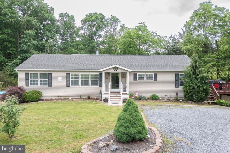 Welcome Home to Your Very Own Peaceful Private Setting away from the Busyness of Life!   This is a well maintained Ranch Style Manufactured home that sits on 2.63 Acres . With Over 3200+  total sq ft., It wouldn't be much to finish the basement completely.     With 3 bedrooms & 2 baths on the main, the basement adds a bonus room that could be utilized as a 4th bedroom!  There is also a basement half bath!
The Kitchen is GORGEOUS!  Check out the modern color palette for the MANY cupboards, the extra vegetable sink, and the Enormous island space with lovely shelving built ins.   Primary bedroom is spacious with a large walk in closet.  
Improvements include newer HVAC, improved alternative septic system, & renovated deck. Outside you can walk the path along the creek,  take a dip in the pool,  sit on your patio next to the water circulating sound of the fish pond, or relax/entertain on the  super nice deck! 

Close to shopping and commuter routes.   Schedule your showing today!!