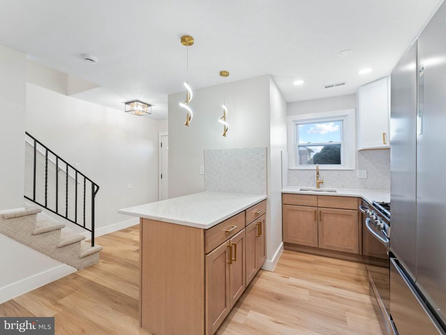 This beautifully renovated townhome offers modern living with stylish upgrades and thoughtful design throughout. The main floor features brand-new luxury vinyl plank (LVP) flooring that flows seamlessly into a stunning kitchen equipped with stainless steel appliances, quartz countertops, and gas cooking. The kitchen boasts a deep sink, dishwasher, and a convenient breakfast bar perfect for casual dining or entertaining. A powder room is located just off the entryway, and laundry facilities are conveniently situated on the main floor. Sliding glass doors open to a private backyard, creating an inviting indoor-outdoor living space.

Upstairs, the LVP flooring continues into the spacious bedrooms. The main bedroom is bright and airy, featuring a sliding door that allows natural light to flood the room, a walk-in closet plus an additional full closet for ample storage. The hallway includes a linen closet for extra organization. The full bathroom showcases a new vanity and a shower/tub combo with elegant floor-to-ceiling tile work. Modern black-finished interior doors add a sleek, contemporary touch throughout the home. The generously sized second bedroom includes a full closet, ideal for family, guests, or a home office.

Located within walking distance to popular restaurants and shopping, this townhome offers both convenience and comfort. It is just minutes from major highways and public transportation, making commuting and exploring the area effortless. This move-in-ready home combines modern upgrades with a prime location, perfect for those seeking style and accessibility.