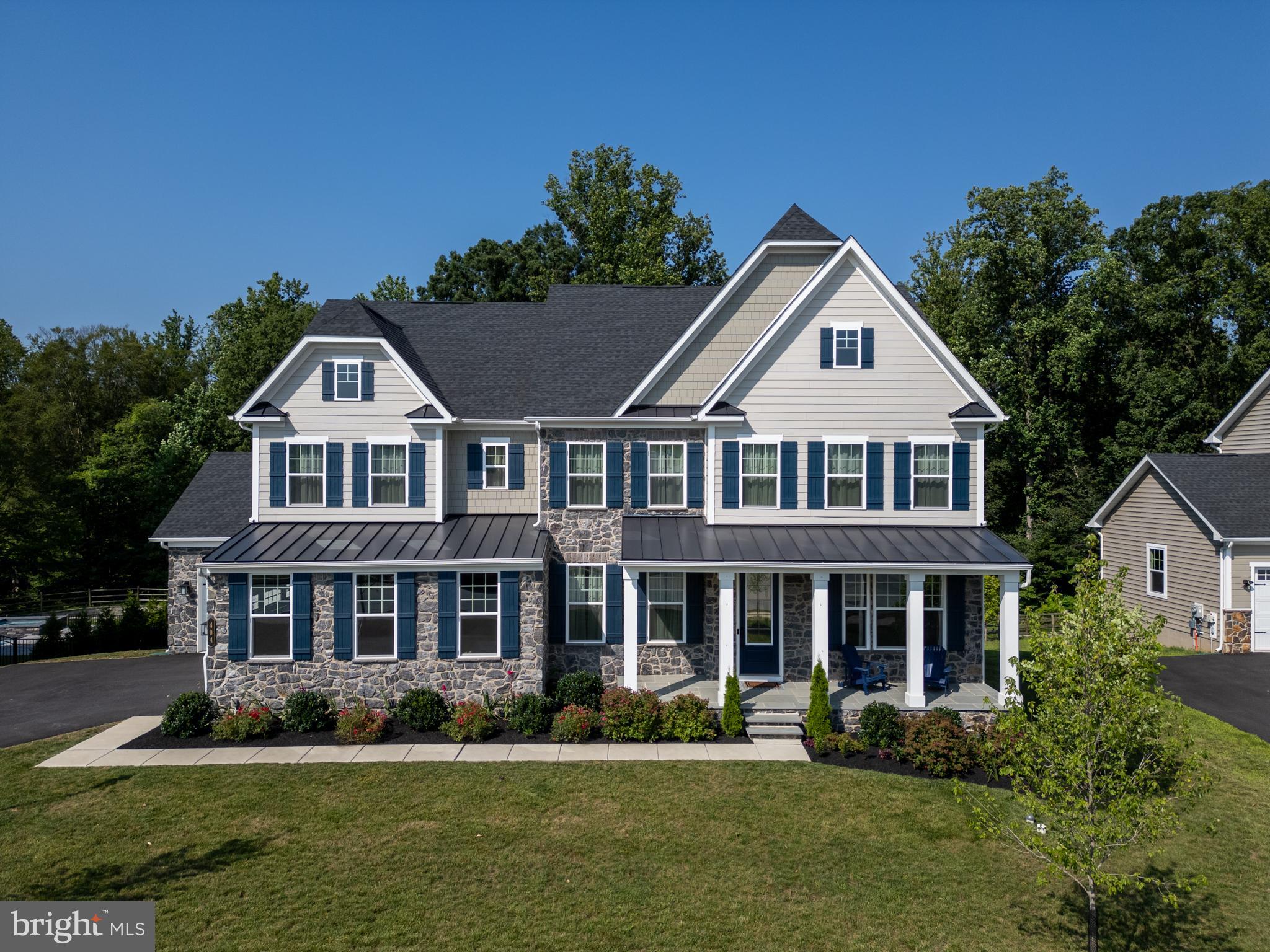Luxurious living in West Goshen’s coveted Greystone community! 404 Armstrong Dr is the builder’s Marymount model, offering an upgraded exterior with 2-story stonework, and a premium lot with mature trees. This is one of the most private lots in the community with a covered deck that overlooks a wooded backyard offering a 3-season view of mature trees and a charming winter view of a pond and stone bridge. Inside, this is an absolutely immaculate home with sweeping living spaces and designer details throughout. The floorplan is incredibly versatile with formal living and dining as well as an open-concept kitchen and family room, where no detail has been overlooked, from the expansive foyer entrance to the back mud room with built-in storage. You could easily set up 2 1st-floor home offices at opposite ends of the home for privacy and quiet working spaces, or you can set up an entry-level bedroom with an adjoining full bathroom. No matter how you utilize the rooms, each space is stylishly designed, and the kitchen adds an additional wow factor. Chic, timeless white cabinetry, a large center island, pantry storage, farmhouse sink, high end appliances, gas cooking, a pot filler, and the list goes on. A stunning floorplan for entertaining, there’s a propane fireplace in the living room for cozy winter evenings, and you can step directly out to the covered back deck for al fresco dining. There are 4 bedrooms upstairs, as well as 3 full bathrooms, including the expansive owner’s retreat with a coffered ceiling, walk-in closets, and luxurious en suite bathroom. Downstairs, the finished walkout basement includes another bedroom plus another full bathroom, and there’s a great room with rough-in plumbing so that you can seamlessly add a built-in wet bar and create the ultimate game-day destination. A truly stunning, turnkey home with so much versatility in a sought-after community! Greystone offers a walkable lifestyle which includes 7 miles of trails, and you’ll be within easy walking distance to Greystone Elementary School. Plus it’s a short, quick drive to West Chester Boro’s vibrant shopping/dining scene. On top of all this, the seller will pay off the balance of the Greystone/West Goshen Township assessment at closing. Request a personal tour today!