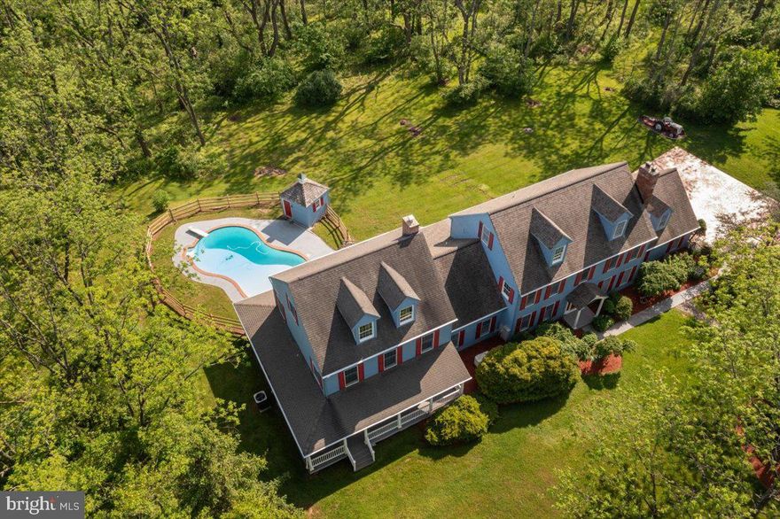 If you are looking for a private secluded setting with a separate au pair, in law suite or potential apartment this is worth a visit.  This 14 acre property has so much to offer.  A beautiful in ground pool, with an impressive wrap around porch to enjoy.  Plenty of room for chickens, build that garden you have been thinking about and sit back while enjoying the nature around you including a peaceful stream.  Boasting over 7500 square feet, this home has a lot to offer for your every need even multigenerational living.  The basement is  finished with a full bathroom, flexible living spaces throughout.  Close proximately to restaurants, shopping centers and cultural attractions while being tucked away in tranquility and healthy lifestyle living.