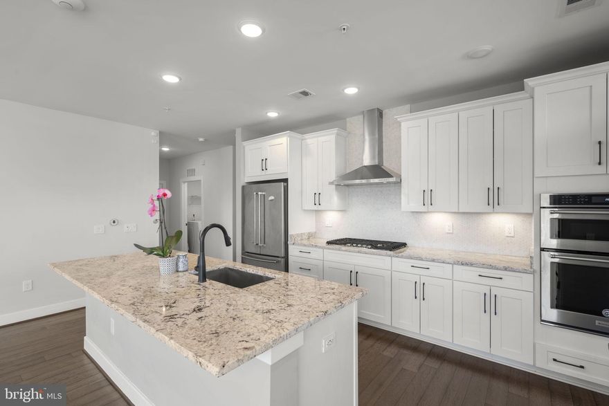 As the largest floor plan in The Lofts at Reston Station, this spacious 2-bedroom (Plus LARGE den with closet space) corner unit shows off with plenty of windows/natural light and private balcony. Constructed in 2019, the home offers an open, airy, and modern layout. The sleek kitchen features modern appliances, cabinetry, counters, and a large island - ideal for entertaining. The primary suite is well appointed with walk-in closet space, closet systems, and a primary bathroom with dual-vanities and a contemporary walk-in shower. Both bedroom floors have been recently updated. Tandem parking space accommodates secure underground parking for two (2) cars. Additional guest parking is available behind the building. Elevator on site. 

The Lofts at Reston Station is a short stroll away from Wiehle Ave-Reston East Metro station along the Silver Line and Rte 267. Access to all of the Reston Association amenities - pools, tennis courts, green spaces, trails, parks, etc. is included. Proximate to groceries, day-to-day conveniences, and all of the restaurants and commerce that Reston Town Center has to offer. In addition to all of the existing attractions at your fingertips, the next-door Reston Row development project will offer a massive upgrade in mixed-use businesses and amenities.