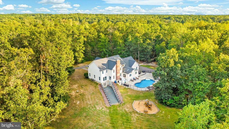 1% Lender Credit available to buyer!!  CUSTOM BRICK ESTATE WITH SALT WATER POOL, GUEST HOUSE AND 3400 SQ FT GARAGE ON 46 ACRES.  Welcome to Your Private Virginia Estate.  Tucked away on 46 serene acres, this custom-built brick estate home offers 6,000 square feet of refined living space, blending timeless architecture with modern luxury.  A circular drive, stately columns and a side load 4 car garage set the tone for the elegance that awaits inside.  Step into the grand two-story foyer, where dual sweeping staircases create a breathtaking first impression.  

The main level boast an eat-in gourmet kitchen with granite countertops, stainless steel appliances and beautiful cherry cabinetry.  Large formal dining room is perfect for entertaining or Sunday dinners.  Work from home in the oversized office or relax in not one but two family rooms.  Off the kitchen, spectacular cabin-inspired addition invites you to unwind with wood beamed ceilings, floor to ceiling stone fireplace and walls of windows that frame your views of the salt water pool with water features and stamped concrete - the ultimate backyard oasis. 

Upstairs, discover 5 bedrooms and three full baths, including a jack and jill layout and a show-stopping "princess suite" that feels right out of a fairytale.  Primary suite is a sanctuary of its own, featuring vaulted ceilings, wood burning fireplace and spa like bath. 

The finished walk out basement is designed for entertaining, complete with a wet bar and kegerator, fitness room, abundant storage and yet another wood burning fireplace to warm the cool Virginia nights.
But the estate doesn't end there.  A separate 3 bedroom, 2 bath rambler with 2 car garage is excellent for multi-generational living or rental income.  
Do you own a business, hobbyist, car enthusiast?  You will be pleased with the 3400 square foot climate controlled garage with vehicle lift, office and bathroom.  The floors are even heated!!   

From its elegant interiors to its resort-style amenities and unparalleled acreage, this estate is more than just a home - it is a lifestyle.