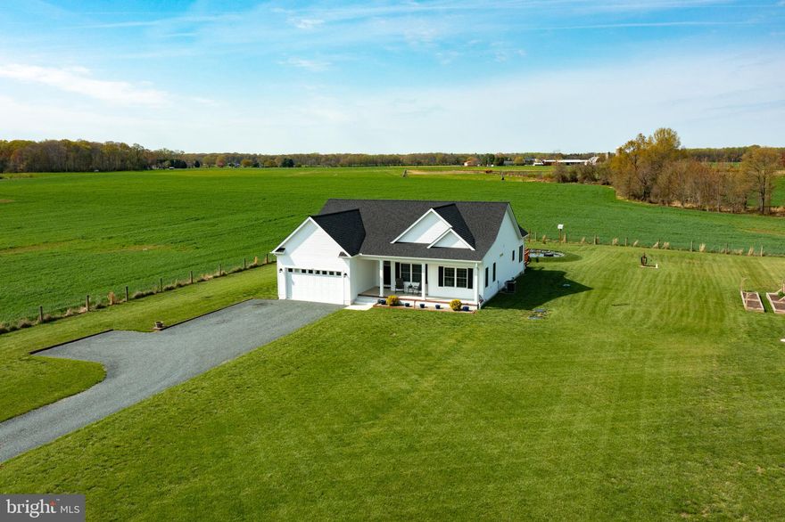 Beautifully maintained 3-bedroom, 2-bath home, just three years old and perfectly situated on 1.25 peaceful acres. Offering 1,838 square feet of living space. Inside, you’ll find an open-concept layout filled with natural light, a spacious living area, LVP flooring throughout, 3' wide doors and a stylish kitchen with granite counters and stainless steel appliances.  The private primary suite features a walk-in closet and full bath with large soak in tub while two additional bedrooms offer flexibility for guests, a home office, or hobbies. Step outside and enjoy the tranquility of your own koi and goldfish pond, ideal for relaxing afternoons on the deck.  The shed with electric provides ample storage or workshop potential, and the expansive yard is perfect for gardening, play, or simply enjoying the outdoors. Home is already set up for your electric car with outlet in garage.  This home offers the best of both indoor and outdoor living—all in a quiet setting with easy access to Rt. 301. Don't miss your chance to own this move-in-ready gem!