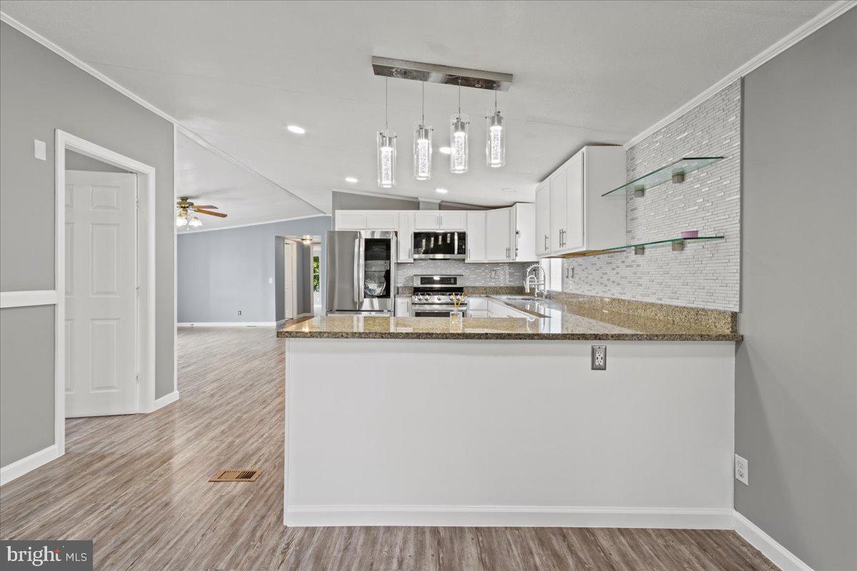 Back on the market, last chance to call it yours! Welcome, where comfort meets convenience in this beautifully maintained 4 bedroom, 2-bathroom home. Nestled in the tranquil community of Lothian, MD, this gem offers an open and airy floor plan. Step inside to a bright, sun-filled living area featuring a cozy fireplace, flowing effortlessly into a spacious kitchen with beautiful cabinetry, a modern bathroom, and a charming dining nook—perfect for family meals or hosting friends in style. Outside, you'll love the patio and included storage shed—perfect for tools, bikes, or extra belongings. Also- As a resident of Boones Estates, you’ll enjoy fantastic community amenities including a basketball court, playground and swimming pool—all just steps from your front door! Conveniently located with easy access to Annapolis, Washington D.C., and nearby shopping, dining, and recreation—this affordable, move-in ready home is the perfect blend of comfort and lifestyle. *Serious buyers only* email or text for immediate response!