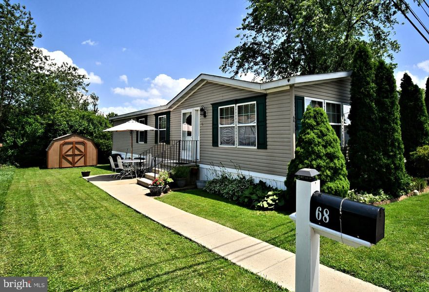 Beautiful 2003 double wide home with 1,680 square feet!  Huge kitchen with breakfast bar,  plenty of cabinets and counters, glass front accent cabinets.  Large bright windows.  Liv ing area is spacious and open with vaulted ceiling in Living, dining and kitchen with sky light.  Main bedroom is roomy with huge walk in closet, private bath with double sinks, soaking tub.   Two additional bedroom and laundry room.  Pergo flooring in kitchen and dining room and entry. The roof was replaced in 2021, the hot water heater was replaced in 2024.  Nice patio, propane heat.