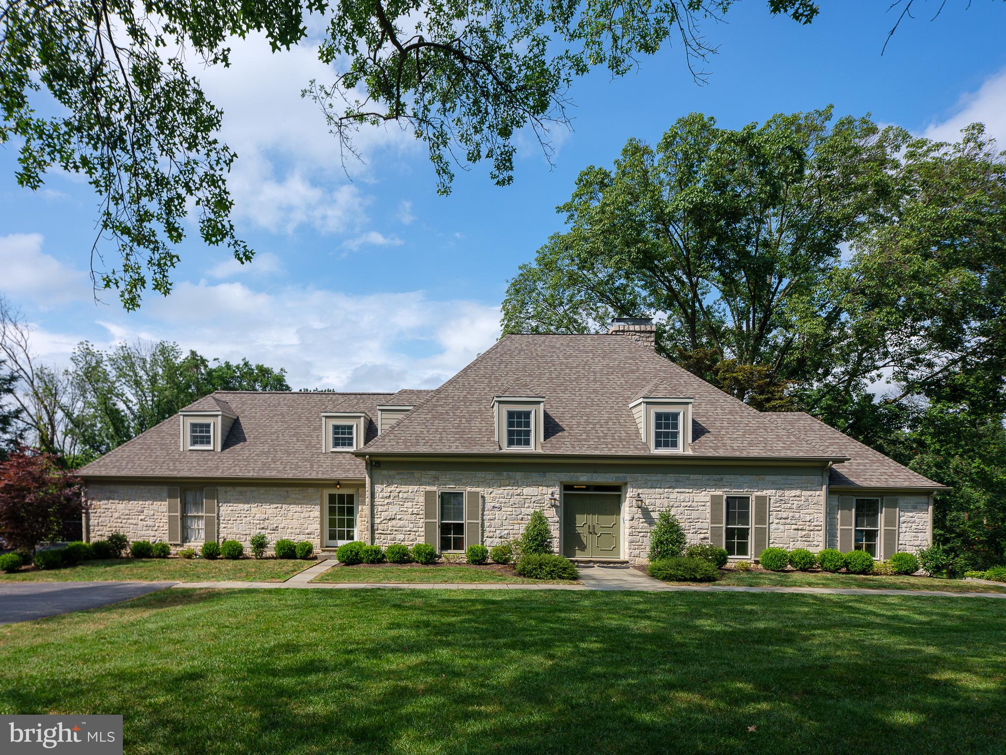 Exceptional setting and exceptional home in fully and tastefully updated condition on an almost 1.5 acre fenced and gated parcel with pool embedded into the conserved grounds of Appleford. A substantial double door opens to a wide foyer with stunning forward views through the handsome living room with fireplace overlooking the rear yard and pool. Richly stained hardwood flooring, found throughout the full first level, leads the eye from space to space further highlighting the home's open floor plan. A wide cased opening from living room to dining room and beyond to the sparkling white fully custom kitchen provides extraordinary views in all rooms from the home's oversized floor to ceiling window and unparalleled natural light. The well planned and appointed kitchen has white cabinets, soapstone countertops and requisite high-end appliances. A seated island performs for casual dining while a step down breakfast area surrounded by windows feels almost like dining outdoors! A wet bar offers flat service space and additional display cabinetry for stemware and wine storage. The current owners saw to the comprehensive renovation of the home and insisted on creating a private home office just off the kitchen. Warmed by southern exposure, the home office provides quiet homework or work space as well as terrific hideaway and locked storage for printers, files and documents. Previously purposed as a first level master bedroom suite, now used as play and home-school area, with this two room suite allowing for maximum flexibility in floor plan. Ascend the main staircase to the primary bedroom suite. The addition of a large dormer provides treetops views of the rear yard. An exquisite bathroom offers an under window soaking tub, stone topped vanities and large seated shower. This main suite offers three closets, one walk-in and two reach-in, for generous outfitted storage. Two large bedrooms share a well designed hall bath while a suite best accessed from the secondary stairs has a bath and vaulted ceiling with natural wood ceiling detail. A second level laundry and plentiful closets space complete this level. A mostly finished lower or garden level opens to the pool as well as to a flat side play-yard. The recreation room offers details including exposed stone, natural wood, and massive fireplace, complimented by large glass doors to the terrace. A bar area is ideal for parties, and large renovated spa-level bath and sauna serve the pool and gym area. A provisions closet and additional seated computer/work area, as well as an unfinished storage room, round out the lower level. Idyllic setting, elevated professionally selected finishes, renovated turn-key home. Look no further.