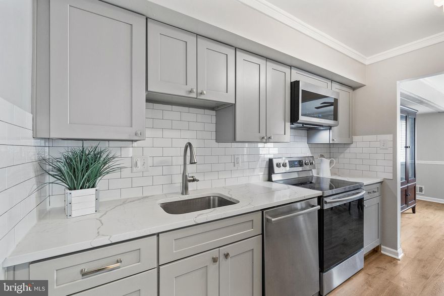 Welcome home to this beautifully updated TOP FLOOR condo in popular Sequoyah! You'll love the many modern updates throughout this special unit! Enjoy the wide plank laminate flooring and FRESH PAINT THROUGHOUT! The gorgeous and completely updated kitchen boasts stainless steel appliances, modern gray cabinets, premium quartz counters, crown molding, and crisp subway tile backsplash! The spacious primary suite features updated en-suite full bathroom and large walk-in closet. Two additional generously sized bedrooms. Both bathrooms have updated vanities, toilets, and fixtures as well as crown molding! The large private deck offers plenty of space for entertaining and relaxing! Newer HVAC (2019) and Nest Thermostat/Doorbell professionally installed. Enjoy COVERED PARKING with assigned carport space below unit (and extra storage!).  Fantastic community amenities include pool, tot lot, community center, and tennis courts. Great location with quick access to transportation, shops, main routes and more!