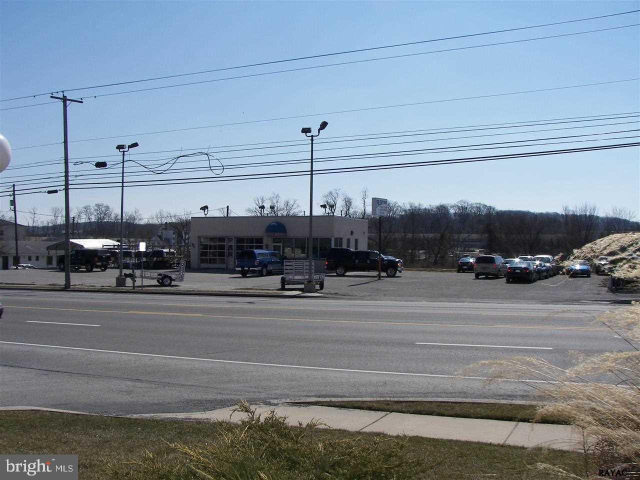 5.1 acres high profile site currently with a 1,296 SF block service building consisting of an office showroom area and 2 large service bays + 1 lavatory, paved 206 ft. frontage parking lot and over 4 acres of developmental land. See attached Environmental reports on decommissioned fuel tanks.