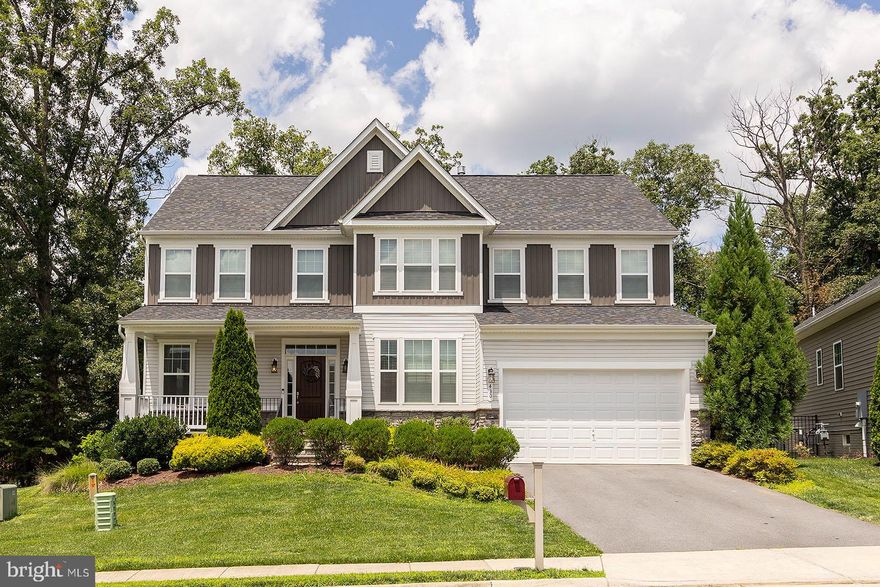 Welcome to this exquisite craftsman-style home that backs to the trees. This former model home offers 5 bedrooms, 4.5 baths, and a generous living space of 4,440 finished square feet, complete with numerous upgrades and luxurious features. As you step inside, you'll be greeted by the elegance of hardwood floors that adorn the entire main level. The open floor plan seamlessly blends the main living areas, creating a spacious and inviting atmosphere. Delight in the intricate details of crown molding and chair railings, adding a touch of sophistication to each room. The main level also boasts a charming library with built-in shelves, perfect for displaying your cherished books and mementos. Prepare gourmet meals in the well-appointed kitchen, equipped with top-of-the-line appliances, ample counter space, and stylish cabinetry. The kitchen effortlessly flows into the sunroom, where you can bask in natural light and enjoy serene views of the surrounding trees. Relax and unwind in the family room, featuring a second gas fireplace that adds warmth and ambiance to the space. On cooler evenings, revel in the cozy glow of the fireplace in the primary suite, which offers a two-sided design, allowing you to enjoy its warmth from both the bedroom and a private sitting room. Convenience is key with a bedroom-level laundry room, making everyday tasks a breeze. The finished basement impresses with high ceilings and offers an expansive recreational area, perfect for hosting gatherings or unwinding with loved ones. Entertain guests at the wet bar, engage in friendly competition in the recreation room, or convert the den into a home office or personal gym. An additional bedroom and full bath in the basement provide ample space for guests or extended family.
Step outside onto the composite deck, where you can savor the tranquility of the wooded surroundings. Whether you're enjoying a morning coffee or hosting a summer barbecue, this outdoor oasis offers the perfect space to relax and soak up the natural beauty. This craftsman-style home with its impressive upgrades, spacious layout, and serene tree-lined location offers a perfect blend of luxury and comfort.