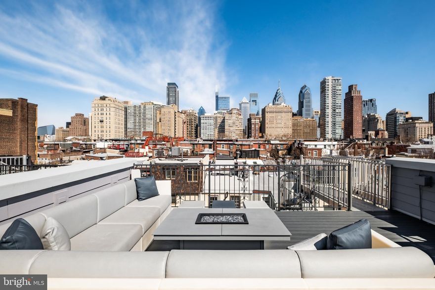Welcome to The Lombard Estates—an exceptional luxury residence ideally situated steps from Rittenhouse Square, a short walk across the bridge to UPenn, CHOP & HUP & located in the prestigious Greenfield School Catchment! Offering over 4,100 square feet of impeccably designed living space, this expansive home blends sophistication, comfort & convenience in one of Philadelphia’s most sought-after locations. Complete with 4 bedrooms, 4.5 bathrooms, a finished basement, private elevator, and a 2-car garage, every detail has been thoughtfully curated for elevated city living. Topping it all off is a spectacular 2-tiered rooftop deck showcasing completely unobstructed skyline views—some of the most breathtaking in all of Philadelphia!  Enter through an elegant foyer, currently styled as a home office, with convenient access to the attached 2-car garage with generous storage. An in-home elevator enhances everyday convenience by allowing easy movement between all levels. It simplifies daily routines and adds flexibility, creating a more comfortable & functional living environment for a variety of needs over time. The second level unfolds as the heart of the home, thoughtfully designed for both daily living and elegant entertaining, with a spacious living & dining area highlighted by gleaming hardwood floors, custom built-ins, a gas fireplace, and charming Juliette balcony. The living room entertainment center features centralized control of built-in speakers, allowing you to enjoy music throughout the living & dining areas, kitchen and even the roof deck! The chef’s kitchen is impeccably appointed with premium appliances, including a Viking refrigerator, Wolf cooktop & double oven, a Miele hood, and Bosch dishwasher. Quartz countertops, high-end cabinetry, and a sleek backsplash blend functionality with sophisticated design. A discreet powder room completes this level. The third level offers 3 generously sized bedrooms with hardwood floors, 2 full bathrooms, and a dedicated laundry room with a Whirlpool washer/dryer + utility sink. The top level is devoted to the luxurious primary suite, where skylights fill the space with sunlight. This serene retreat features a spacious WIC with custom built-ins, and a spa-like bath. The luxurious bath is appointed with a NuHeat radiant floor heating system, a tiled shower, dual vanities, and a soaking tub designed for ultimate relaxation. Just outside the primary suite, a convenient wet bar makes entertaining effortless as you step out onto your incredible rooftop deck. Whether hosting guests or enjoying a quiet evening, the 2-tiered outdoor space offers ample room for dining, grilling, and taking in sweeping, unobstructed views of the city skyline. The roof deck is fully equipped for outdoor dining, featuring a kitchen with a BBQ, refrigerator, and sink. A built-in gas fire pit creates the perfect setting for evening cocktails under the stars. Have peace of mind knowing that the fiberglass roof was refinished in 2019 prior to installation of Trex style roof decking. The fully finished lower level presents an impressive extension of living space, featuring a generous family room, a thoughtfully designed bar for entertaining, and a temperature-controlled wine cellar. The level also features a full bathroom and can easily be used as private living space for an au pair as an alternative option. The basement houses an in-home water filtration system along with an plenty of finished storage space. Smart home features include a Control4 automation system that lets you manage lighting, temperature & security with ease. Set programmable timers for lighting & adjust the climate throughout the home—all from an app, with remote access via subscription. Enjoy nearby dining favorites like Rival Bros, Friday Saturday Sunday, Illata, Pub & Kitchen & Southgate. Rittenhouse Market is just 3 blocks away. The Schuylkill River Park, Markward Playground, tennis courts & dog parks are all close by!