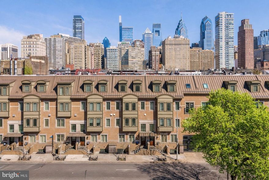 Welcome to The Lombard Estates—an exceptional luxury residence ideally situated steps from Rittenhouse Square, a short walk across the bridge to UPenn, CHOP & HUP & located in the prestigious Greenfield School Catchment! Offering over 4,100 square feet of impeccably designed living space, this expansive home blends sophistication, comfort & convenience in one of Philadelphia’s most sought-after locations. Complete with 4 bedrooms, 4.5 bathrooms, a finished basement, private elevator, and a 2-car garage, every detail has been thoughtfully curated for elevated city living. Topping it all off is a spectacular 2-tiered rooftop deck showcasing completely unobstructed skyline views—some of the most breathtaking in all of Philadelphia!  Enter through an elegant foyer, currently styled as a home office, with convenient access to the attached 2-car garage with generous storage. An in-home elevator enhances everyday convenience by allowing easy movement between all levels. It simplifies daily routines and adds flexibility, creating a more comfortable & functional living environment for a variety of needs over time. The second level unfolds as the heart of the home, thoughtfully designed for both daily living and elegant entertaining, with a spacious living & dining area highlighted by gleaming hardwood floors, custom built-ins, a gas fireplace, and charming Juliette balcony. The living room entertainment center features centralized control of built-in speakers, allowing you to enjoy music throughout the living & dining areas, kitchen and even the roof deck! The chef’s kitchen is impeccably appointed with premium appliances, including a Viking refrigerator, Wolf cooktop & double oven, a Miele hood, and Bosch dishwasher. Quartz countertops, high-end cabinetry, and a sleek backsplash blend functionality with sophisticated design. A discreet powder room completes this level. The third level offers 3 generously sized bedrooms with hardwood floors, 2 full bathrooms, and a dedicated laundry room with a Whirlpool washer/dryer + utility sink. The top level is devoted to the luxurious primary suite, where skylights fill the space with sunlight. This serene retreat features a spacious WIC with custom built-ins, and a spa-like bath. The luxurious bath is appointed with a NuHeat radiant floor heating system, a tiled shower, dual vanities, and a soaking tub designed for ultimate relaxation. Just outside the primary suite, a convenient wet bar makes entertaining effortless as you step out onto your incredible rooftop deck. Whether hosting guests or enjoying a quiet evening, the 2-tiered outdoor space offers ample room for dining, grilling, and taking in sweeping, unobstructed views of the city skyline. The roof deck is fully equipped for outdoor dining, featuring a kitchen with a BBQ, refrigerator, and sink. A built-in gas fire pit creates the perfect setting for evening cocktails under the stars. Have peace of mind knowing that the fiberglass roof was refinished in 2019 prior to installation of Trex style roof decking. The fully finished lower level presents an impressive extension of living space, featuring a generous family room, a thoughtfully designed bar for entertaining, and a temperature-controlled wine cellar. The level also features a full bathroom and can easily be used as private living space for an au pair as an alternative option. The basement houses an in-home water filtration system along with an plenty of finished storage space. Smart home features include a Control4 automation system that lets you manage lighting, temperature & security with ease. Set programmable timers for lighting & adjust the climate throughout the home—all from an app, with remote access via subscription. Enjoy nearby dining favorites like Rival Bros, Friday Saturday Sunday, Illata, Pub & Kitchen & Southgate. Rittenhouse Market is just 3 blocks away. The Schuylkill River Park, Markward Playground, tennis courts & dog parks are all close by!