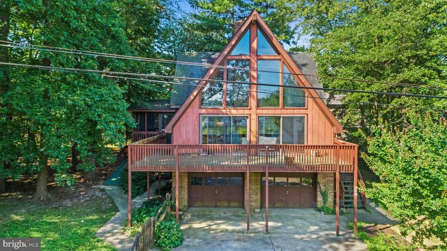 Floor to ceiling windows with a beautiful view of Almshouse Creek! This water view home is beaming with natural light! Enjoy barbecuing and entertaining on the large front deck with access to the screened porch.  Floor to ceiling brick fireplace will keep you cozy on those cold winter nights.  Hardwood floors on upper two levels with updated kitchen, exposed beams in the large family room and spacious lower level for extra living space are just a few things that make this home special.  Bring your kayaks and paddle boards and walk across the street to the water! Hop on the boat and you'll be out to the South River or Chesapeake Bay in no time. Community amenities include multiple marinas, beaches, boat ramps and playgrounds. Shopping, schools and restaurants close by.  Just 10 minutes to Annapolis and easy access to Rt 50 and 97 for commuting to Baltimore or Washington DC.  Come see why you should make this your next home!  ***Adjacent lot on Webster Place is also for sale***