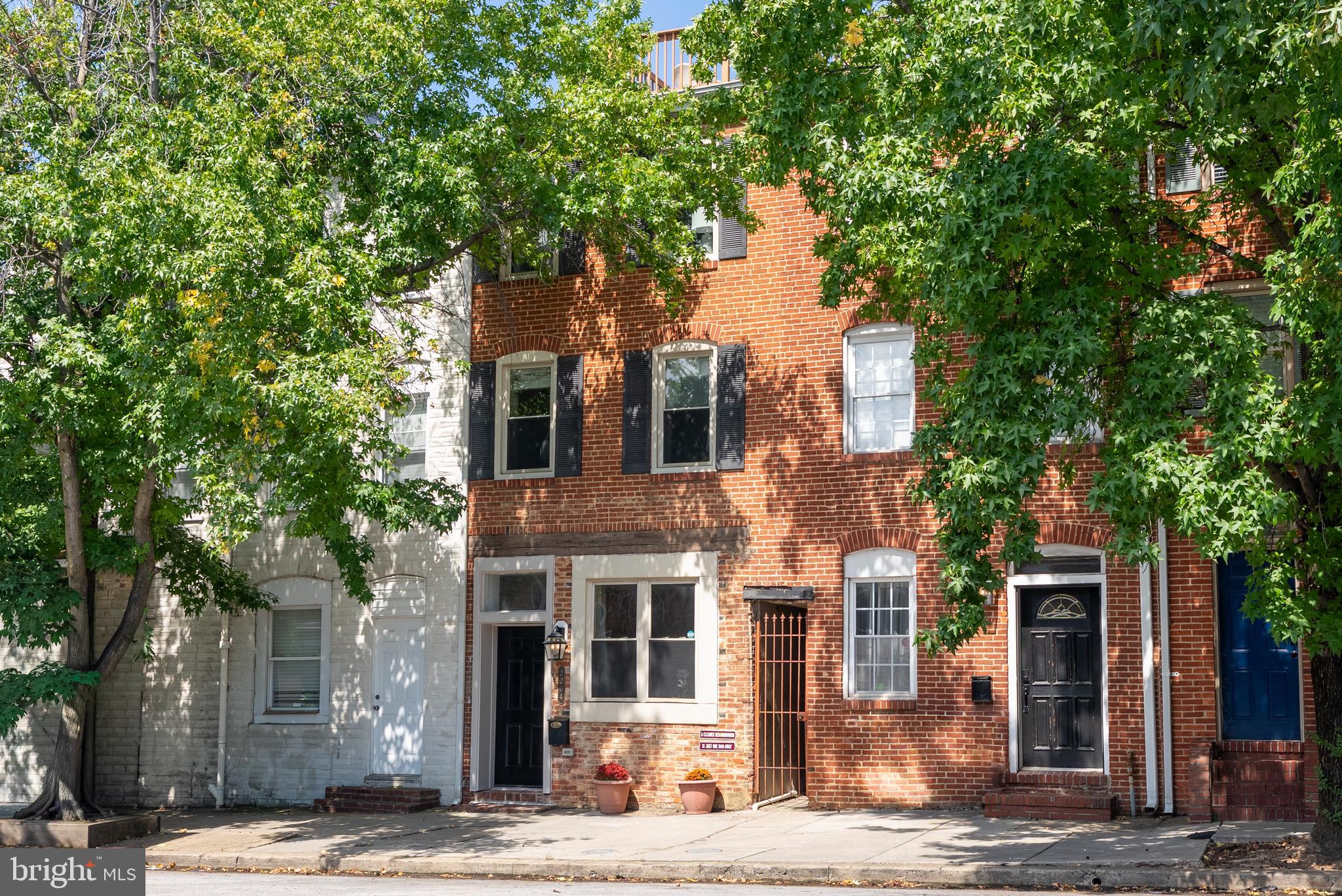 Step inside this stunning three-story rowhome with elevated rooftop deck, where modern luxury meets classic charm, nestled between the vibrant energy of Canton and historic Fells Point. This prime location places you a mere 500 feet from the serene waterfront, offering easy access to strolls along the promenade.
The open-concept main floor is an entertainer's dream, featuring hardwood floors, open riser stairs, and a coffered ceiling with a warm exposed brick accent wall. For added convenience, a half-bath is thoughtfully placed on this level, perfect for guests.
The gourmet kitchen shines with marble counters, a large island, and stainless steel appliances, all topped by an elegant tray ceiling.
The home's middle level offers two bedrooms, a stylishly tiled full bathroom, and a conveniently located laundry room, making everyday chores effortless.
The expansive upper level is dedicated to the luxurious master suite, featuring a vaulted ceiling that enhances the space and an opulent, tiled en-suite bathroom. This floor also hosts a utility closet and versatile bonus room, a perfect space for a home office or gym, which leads to your private urban sanctuary: a breathtaking rooftop deck. This is your front-row seat to spectacular city skyline views and unforgettable sunsets.
With abundant natural light, sophisticated finishes, and detailed moldings throughout, this home isn't just a place to live—it's a lifestyle.