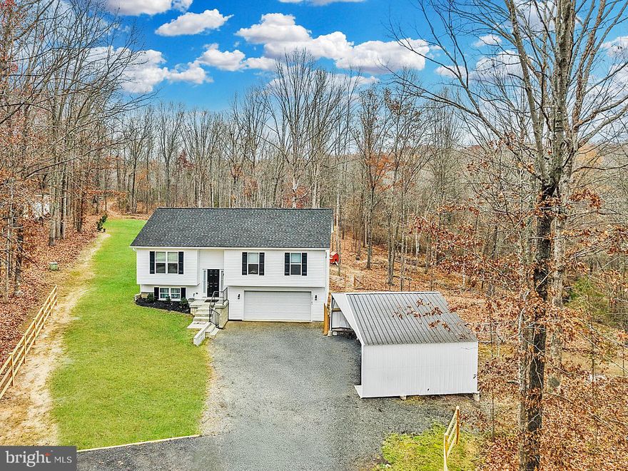 Discover this beautifully maintained 3-year-old home situated on 6.3 private acres with no HOA! A long driveway leads you to a peaceful, secluded setting. The property features newly created four-wheeler trails, a stream running through the land, and a brand-new wooden fence on one side of the property. There is a newly installed power inlet box so you can power the house with a portable generator. The fenced in area is perfect for pets and livestock.  Along with the 2 car attached garage, there is a spacious 3+ car detached carport that offers plenty of room for additional vehicles, equipment, and all your outdoor needs. Inside, enjoy an open floor plan where the living room flows seamlessly into the dining area and gorgeous kitchen—perfect for cooking and entertaining. You will love all the natural light here! The upper level includes 3 bedrooms, including the spacious primary bedroom suite. The lower level offers the 4th bedroom, the 3rd full bathroom, and a generous rec room, ideal for additional living space, hobbies, or guests. Enjoy the nearby battlefields, farmers market, Motts Run Reservoir, wineries, and Lake Anna State Park.  No need to wait for new construction! This is a rare combination of privacy, acreage, and modern comfort—don’t miss this one!