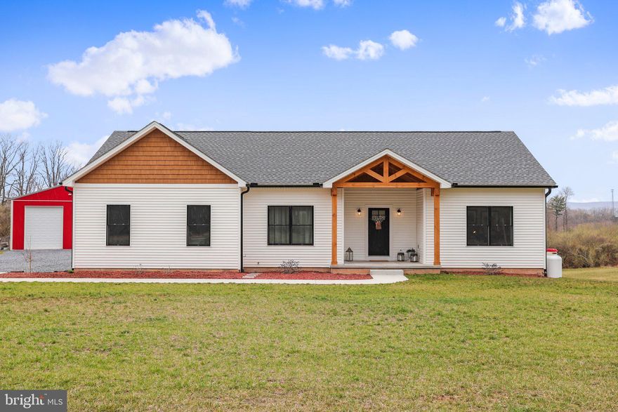 This breathtaking property could be yours! Brand new and built in 2022, this gorgeous raised ranch-style home is a true gem. With nearly six acres of open field and level ground, this property can be used in many different ways. When you walk inside the home, you will notice how bright and airy it feels thanks to the westward facing windows, built to take in the stunning sunsets each evening. Blonde luxury vinyl plank flooring is laid throughout the main areas to create an open and cohesive look. Custom hickory cabinets are accented with black hardware and topped with gleaming quartz countertops. Cozy up in the living room with the press of a button next to the gas fireplace. A full primary suite offers a walk-in closet, dual vanity sinks, tiled floor, and walk-in shower. First floor laundry is located right outside the primary bedroom. On the opposite side of the home, two additional bedrooms and full bath complete the main floor. A full walk-out basement provides more opportunity for additional living space, a workshop or work-out area, or entertainment room. The possibilities are endless. Plumbing has been roughed in for a future bathroom. The outside area is just as incredible as the touches inside. Enjoy watching bountiful wildlife roam the yard from underneath the covered patio. The property is complete with a detached 30 x 40 ft garage that boasts a 14 foot automatic garage door. Park your RV conveniently and directly connect to the sewer and electric hook ups. So much potential exist in this garage for hobbyists or skilled trade workers. All of this and it is only a few minutes from town, convenient to groceries, shopping and Route 30. 
295 Mountain Vista Drive is ready for it's next family. Schedule your tour today and make it your home forever!
