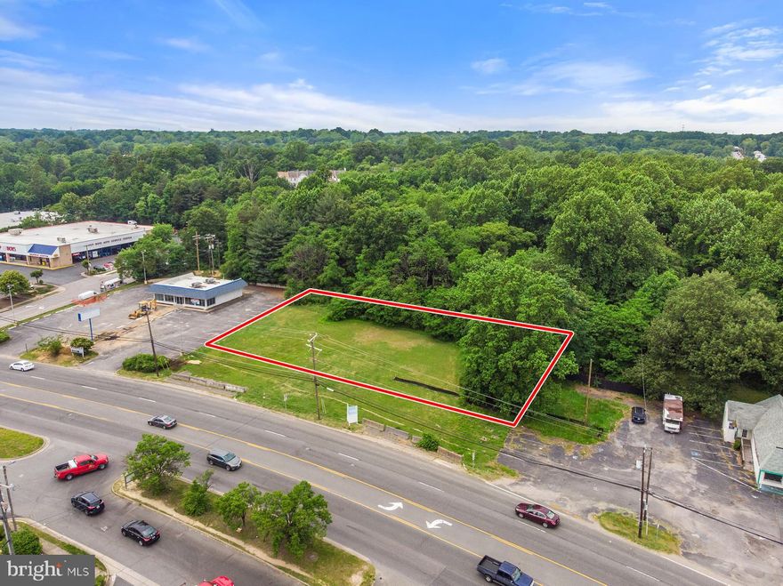 Investment or development opportunity sited directly on Jefferson Davis Highway (Route 1) in Woodbridge, Virginia near intersection with Prince William Parkway!  Lot sits across from Wendy s and King Pollo casual restaurants and just down the street from four major new car dealerships.  Nearby Marumsco Plaza Shopping Center is a popular and well-known retail destination with Big Lots, Walgreens, numerous banks, retail stores, and neighborhood restaurants.  Route 1 is a major commuting corridor as residents commute north to employment centers in Fairfax County, Fort Belvoir, the Pentagon or Washington DC, with 45,000 vehicles passing this area daily.Current Prince William County zoning for this parcel is B-1 General Business, allowing retail, office, and institutional use.  This area is part of the  New Woodbridge  (www.NewWoodbridge.org) development emphasis with investment currently underway, to include widening of Route 1.  Long-term county zoning overlay for this land is GC General Commercial, which will permit and attract larger scale retail and services to support customers throughout the region.  Possible uses include retail, bank or financial institution, casual dining, fast food, and other similar neighborhood stores. The pad site is primarily flat, mostly cleared, and backs to trees.  Public water and public sewer are available and electricity is nearby, as this land sits between existing businesses.