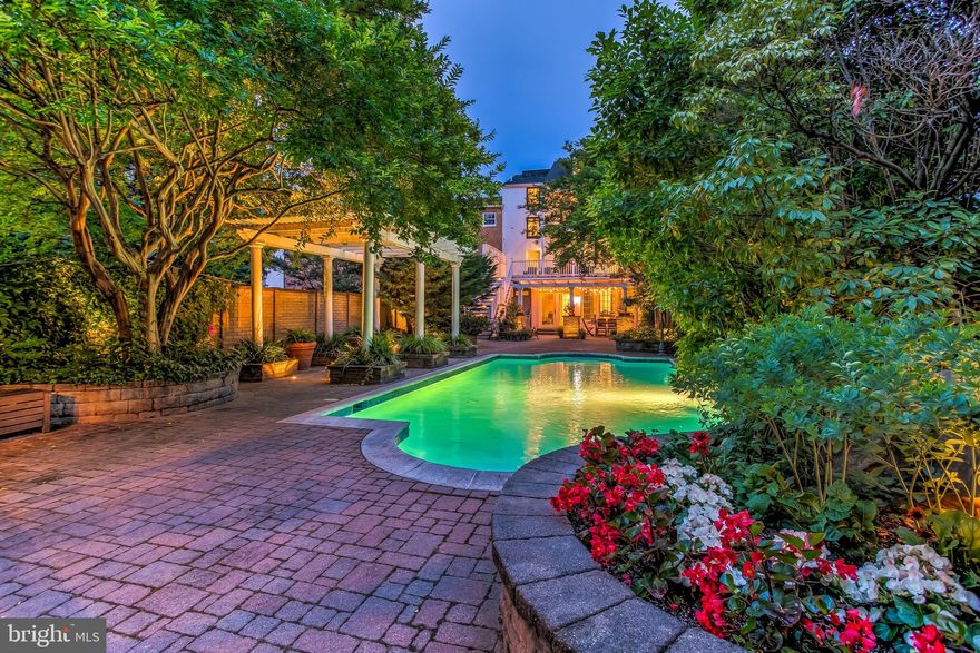 Like no other. Less than half a block from the dining, shopping and waterfront merriment of Thames Street, sits on the calm, tree canopied stretch of Bond Street, the most unexpected treasure of a Baltimore home.Stepping off the sidewalk, through the front door and into a welcoming foyer, one is immediately confronted by the home's layered charm and its understated elegance, a current taste flattering the details of centuries passed. French doors, cut into a wall of exposed two hundred year old brick, mark the transition between the 1860's 828 Bond and the conjoined 1780's 830 Bond. A formal living room sits just off the foyer and despite its immediate proximity to the rushing sidewalk, feels miles away from the excitement of outside. Its design exemplifies the home's aesthetic; craftsmanship of the past presented with the clean symmetry of today. Just beyond the living room, through the updated kitchen (another example of the modern and the timeless with its dark grouted geometric subway tile playing off the tin ceiling), one finds another rare gem: a large dining room, more like an urban ballroom. Nearly 500 square feet of hardwood floors and against a wall of windows, this space is an entertainer's dream and the possibilities for eventual kitchen expansion have endless potential. Through the dining windows is a view enjoyed by no one else this side of Guilford or Roland Park:  the jaw dropping back patio and heated swimming pool. Occupying what feels like its own double lot, the back patio is a wonder of downtown living. Extensively hardscaped, the private outdoor space with its walled perimeter features tall trees stationed as cornered sentries. Parking for FOUR cars sits just outside the secure gate, just next to the gazebo. The seclusion is disorienting and the hurried momentum of the city quickly fades.What about upstairs? Coming across the second-floor landing, one passes a bedroom with private bath and enters into a generous den with several windows forming a tree-top triptych with sunlight pouring through the branches. A small stairwell leads to a wet bar complete with wine fridge and refrigerator; a second bedroom to the right and another full bath to the left. A door leads to a large, second floor deck that overlooks the pool. On the third floor, a stunning master suite. French doors open to a large sitting room with a gorgeous tray ceiling and woodburning fireplace. A large archway leads to the sleeping quarters, another woodburning fireplace sits at the foot of the bed, flanked by built-in bookcases and a balcony looks down upon the treetops of the back patio. Off of the sitting room, another small set of stairs leads down into a large dressing room (with laundry) and the breathtaking master bathroom  a two story, marble-tiled masterpiece with soaking tub, dual vanities and an open shower. The fourth floor brings two more bedrooms and another updated bathroom, the roof lines and the window dormers create an eye pleasing geometry of modern lines and cozy nooks.  The history of this place affirms its stately presence. The home of privateer captain Thomas Winning, 830 Bond Street was built in 1783 and gifted to his daughter shortly thereafter. Before the War of 1812, it became the home of Daniel James, the innkeeper of Thames Street. Over the following two hundred years, as it became combined with 828 Bond, taking on its address, evolving into its current grandeur, it has always been regarded as the finest house on the block.