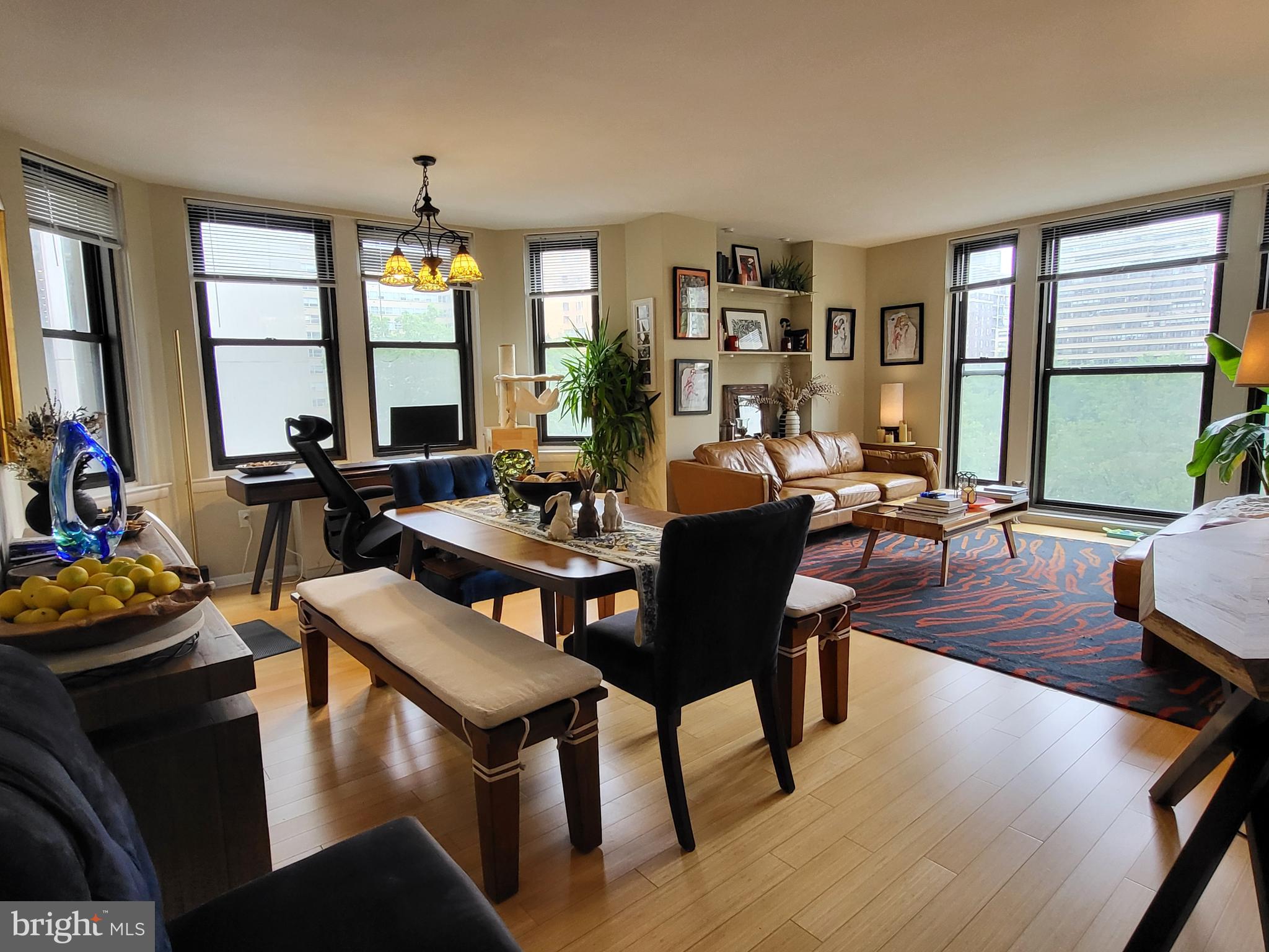 Two bed, two bath featuring treetop views of Rittenhouse Square at The Wellington! This sun-soaked home boasts views of Rittenhouse Square through oversized bay windows and hardwood floors throughout all living areas. There is a grand living room that sits adjacent to a separate dining area with a chandelier. The well-equipped kitchen has white shaker cabinetry, gray countertops, stainless steel appliances and access to a stackable GE/Whirpool washer/dryer. Both bedrooms are spacious in size and have excellent natural light, great closet space and carpet flooring. The first bedroom enjoys use of an ensuite bathroom, while the second bedroom enjoys use of a nearby full hall bathroom. Both bathrooms have glass enclosed showers and single vanities with white cabinetry. The Wellington is a pre-war apartment building located on Rittenhouse Square offering a 24 hour doorman, on-site management, and access to a nearby fitness center at 1845 Walnut.