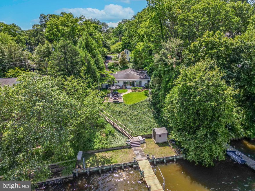 Experience stunning sunsets over the tranquil Severn River from this waterfront oasis! Boasting 61 feet of water frontage, complete with a bulkhead, pier with newer deck boards (2022), and a rebuilt 12,000-pound lift (2022), this property is a boater's dream. The outdoor patio, along with the living room, breakfast area, and kitchen, all face the river, providing breathtaking water views. Inside, enjoy three generous bedrooms and two full bathrooms, offering cozy retreats with ample space and comfort. The living spaces feature elegant walnut wood floors, and the custom kitchen boasts a spacious island, granite countertops, and stainless appliances (2014). A detached 24x24-foot garage with pull-down stairs to a floored attic offers ample storage. The main residence has the potential for expansion up, per the BAT septic (2015) and Bay Restoration Fund Grant agreement. Imagine adding an entire owner's suite with 867 square feet overlooking the river! Arden on the Severn is a vibrant and lively neighborhood, perfect for all ages! The ACA hosts a variety of activities, including a teen club, kids club, and senior lunches, all centered around their community-owned town hall. ABI manages five community beaches, three boat ramps, three fishing piers, a dinghy dock, and rental spaces for kayaks. Enjoy summer festivities at the beaches, Tent-or-Treat at Halloween, and a festive Christmas parade in winter. There's always something fun to participate in!