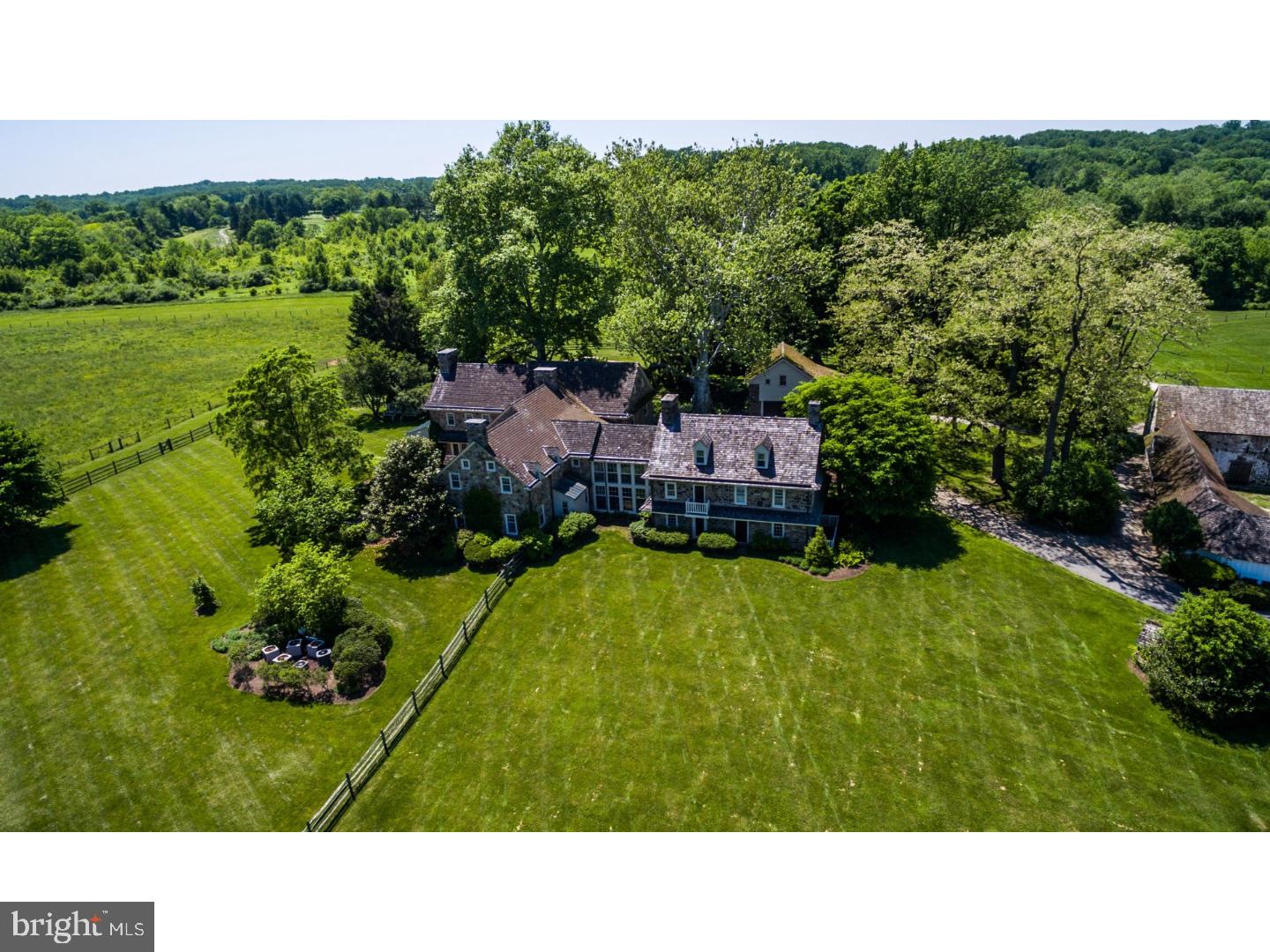 Welcome to 736 White Horse Rd Berwyn- a once in a lifetime estate in the heart of Radnor Hunt. Encompassing over 45 breathtaking acres, this property offers a traditional stone farmhouse with 5 bedrooms and 5.2 bathrooms. The original home built in the early 1700s was added onto in 1999 with a magnificent addition that flawlessly combines old and new. With over 11,000 square feet, this home offers formal but open living space to meet today's buyers needs. The updated kitchen with inset cabinetry, commercial grade appliances, granite tops, and attached butlers pantry overlooks the family room with wood beamed ceiling, wood burning fireplace, and attached game room that overlooks the grounds. The formal dining and living rooms both with fireplaces and traditional mill work are perfect for large gatherings with french doors opening to the stoned patio. Both are adjacent to the stunning foyer with extensive millwork and a fabulous bar area with beverage fridges, wet bar, and storage space. The original part of the home offers a cozy living room and den which are the perfect spaces to escape the chaos of the day for ones own private retreat. The second level offers a luxurious master suite with expansive bedroom with balcony overlooking the sprawling grounds; his and her bathrooms and closets, and sitting area. There are 4 other spacious bedrooms- 1 princess suite with built-in desk and cabinetry and 3 bedrooms with fireplaces and one with balcony. All bathrooms are updated and coordinate with adjacent bedrooms. The basement is partially finished and offers bonus space for a gym or lounge area. The exterior has a flagstone pool with hot tub with magnificent views for miles and a traditional barn that is perfect for storage and large equipment. There is a 2 car garage with an updated studio apartment for guests and a recently renovated 3 bedroom, 2 bathroom cottage with 2 car garage. This house is close but private from the main home ideal for multigenerational living or as a care taker's cottage. 736 White Horse Rd is not to be missed and allows country living while being minutes to downtown Wayne and all major roadways for an easy commute to Philadelphia, Wilmington, or NYC. Located within Top Rated Great Valley schools while close to Epis. Academy, Malvern Prep and Agnes Irwin. This property truly has it all; make your appointment today!