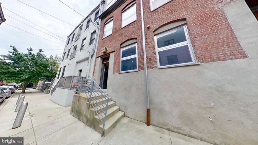 Welcome to the Callowhill Industrial Historic District. This unique artisanal dwelling is the labor of an amazing designer. The custom metal staircases and handmade dining table are works of art. This is an ideal address to live in one unit and produce income in the second unit. The first floor is one bedroom and one bath totaling 1650 square feet.  The exposed brick foyer leads you to an open floor plan with polished concrete floors, massive kitchen island,  and high ceilings.  Heading towards the back you have separate bedroom, a second den or bedroom with loft built above and  the bathroom.  French doors open to the patio with an artsy metal enclosure, a former loading dock that sits above the cobblestone street. Upstairs consists of the second and third floors and has a total of three bedrooms and two full baths with a total of 2500 square feet.  Again, you will find a totally open floor plan with century old timber beams, oak hardwood floors, exposed brick walls. French doors lead you out to the expansive deck that needs to be seen to be appreciated.  There are beautiful metal corten planters and one of a kind custom awning on the deck.  One bedroom and one full bath adorn the second floor, two bedrooms and one bath on the third floor. Third floor also boasts another large living room with hickory floors, floor to ceiling windows and vaulted ceilings. This is for the buyer looking for something beyond the cookie cutter abode. One car gated parking spot #7. What was once a gritty urban neighborhood,  is now burgeoning into the new sassy place to be with local breweries, pop up beer gardens, art galleries and the famous Railpark.  Mere blocks from center city, prime location!