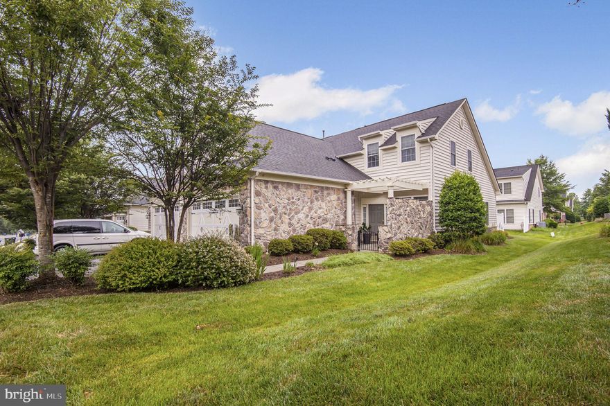 Discover comfort, style, and convenience in this beautifully appointed semi-detached townhome, located in the highly desirable 55+ community of Potomac Green. With two fully finished levels, this spacious residence offers a well-designed layout perfect for both everyday living and entertaining. The home welcomes you with a charming front courtyard and a private rear patio—ideal for relaxing outdoors. Inside, the modern kitchen features granite countertops, stainless steel appliances, a breakfast bar, and sleek cabinetry. The bright and open main level includes a generous primary suite with sunlit windows, a private en-suite bath, and a large walk-in closet. A second bedroom or optional home office, a full hall bath, and a convenient laundry room with washer and dryer complete the main floor.  Upstairs, you’ll find an airy loft space—perfect for a reading nook or quiet retreat—alongside another spacious bedroom and full bathroom, ideal for guests or extended stays. The home also features a two-car garage for added convenience. Enjoy a vibrant lifestyle with access to Potomac Green’s 29,000 sq. ft. clubhouse, offering a state-of-the-art fitness center, aerobics studio, grand ballroom, tennis, pickleball, and bocce courts, plus both indoor and outdoor pools. Just minutes from shopping and dining at One Loudoun and with easy access to the Silver Line Metro, this home offers the best in active adult living. CAC replaced 3 years ago.