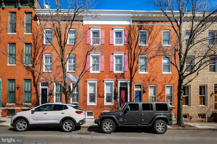 Beautiful 3-story Federal Hill home has tons of character with original wood floors and exposed brick plus PARKING! 3 bedrooms (all above ground), 2.5 bathrooms, 2 decks, and a finished basement in an outstanding location close to all the area attractions. 1st floor has an open layout with a front living room, separate dining room, powder room, beautiful kitchen with stainless appliances, granite counters, breakfast bar, and gorgeous painted maple cabinets & rear family room that walks out to the parking pad. The 2nd floor has 2 bedrooms and a full bathroom in the hallway. The 3rd floor has a large primary bedroom, full bathroom and private deck. The finished lower level could be a home office/play room/guest room.