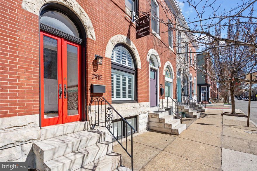 Fully remodeled 3BR/3BA attractive classic Baltimore brick Townhome located in the desirable neighborhood of Patterson Park. The bright red double doors lead you inside to a cozy vestibule and then into the main floor of your forever home.  The main floor boasts beautiful original hardwood floors, tons of natural light, and an open floor plan separated by the open double sided staircase. The spacious living room features a custom wall detail and custom window shutters. Step through into the spacious dining room, and a kitchen boasting an exposed brick wall, plenty of cabinets finished with crown moldings, open shelving, stainless steel appliances, a corner sink under a window, and a row of cabinets with a custom wood countertop. The original hardwood floors continue onto the second floor into a spacious secondary bedroom, a full bath with walk-in shower, and an oversized primary suite.  The primary boasts a glamorous en suite offering a dresser vanity with a vessel sink, and a deep claw foot tub. On the carpeted lower level you will find additional living space with the third bedroom, a full bath, a spacious family room, storage, laundry, and a walk-out to Bilco doors in the fenced yard that could easily be converted into an off-street parking pad.  This home is move-in ready with so much to offer new homeowners and is located across the street from Patterson Park offering tons of green space, a pool, ice-skating, and a lake.  Imagine all this and in close proximity to shopping, restaurants, and commuter routes - this is a must see!