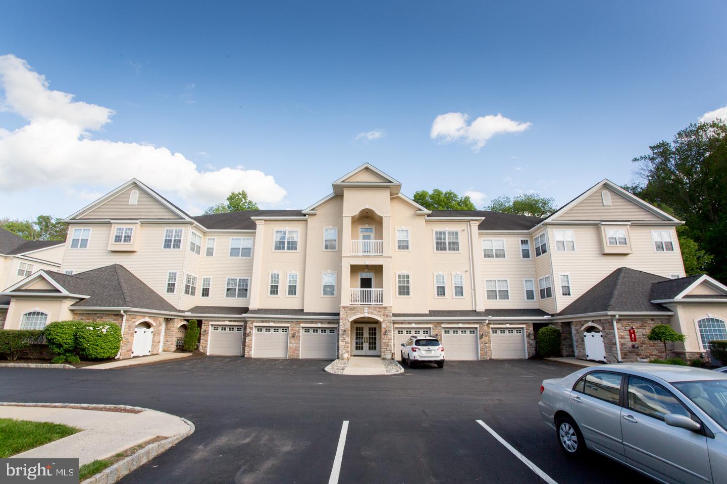 Come See this Fabulous condo located in the 55 Plus Community, Holland Preserve, before it is gone! This wonderful 2 Bedroom, 2 Bath condo is a spacious 1630 Square Feet and is a CORNER UNIT giving you an Abundance of Windows and Natural Light in every corner of the property. From the moment you enter the Grand Foyer which boasts HARDWOOD Floors and ARCHITECTURAL COLUMNS, you will be quite impressed with this space. The large Living Room is enhanced with Crown Molding and Sliding Doors which lead to a Tiled Covered BALCONY. Additional Columns lead you to a Formal Dining Room which also features Crown Molding and a Chair Rail. The Kitchen boasts 42" WHITE CABINETS, a Large Pantry and a generously sized BREAKFAST Room which is filled with sunlight due to the additional windows that come with a Corner Unit. The Master Bedroom is spacious and also has been upgraded to include Crown Molding, Custom Built-In Furniture and a PROFESSIONALLY DESIGNED WALK-IN CLOSET. Adjoining the bedroom is a Beautiful Bathroom that comes with the comforts of a Large Walk-In Shower and a Vanity with a Double Sink. Additional cabinetry can be found here for extra counter space and storage. A Guest Bedroom with a large Closet and a Guest Bathroom with a Vanity and Tub is Perfect for your guests. The Laundry Room is conveniently located just off of the Foyer along with additional closet space. This unit has Ceiling Fans w/ Lights, Designer Light Fixtures and Neutral Color throughout. In additional to all of the wonderful upgrades in this unit, this condo comes with not one but 2 GARAGES, giving you added storage space and the ability to park 2 cars in garages that give you secured inside access to your lobby and elevator to your condo. The Condo fee includes Snow, Removal, Lawn Care, All Common Maintenance and Exterior Maintenance. Although located in beautiful Bucks County, this community is ideal for its convenient access to Montgomery County, Philadelphia and New Jersey.