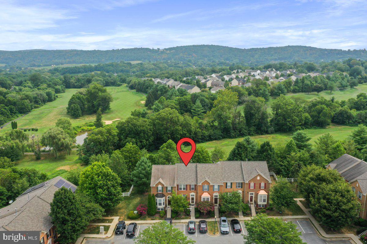 Welcome home where you will be in the heart of Middletown’s desirable Glenbrook community! This spacious 4-bedroom, 3.5-bath townhome offers over 2,600 sq. ft. of beautifully finished living space across three levels with scenic golf course and mountain views as your daily backdrop. The main level boasts hardwood floors throughout an open layout, featuring a bright living room with crown molding, a dining area, and a cozy family room perfect for entertaining. The gourmet kitchen is equipped with granite countertops, an island, pantry, and gas cooking. Upstairs, the primary suite offers a true retreat with a sitting area, large walk-in closet, and spa-like bath complete with soaking tub, walk-in shower, and two sinks. Two additional bedrooms share a stylish full bath with new flooring and a tub/shower combo. The fully finished walkout basement adds serious flexibility with a fourth bedroom, full bath, rec room, and office—ideal for guests, a home gym, or work-from-home setup. Step out onto your private deck and enjoy low-maintenance living with lawn care included by the HOA. If you are a golfer you can obtain a membership as well. All of this is located just minutes from schools, parks, restaurants, and commuter routes. Space, comfort, and views—it’s all here. Don’t miss your chance to live in one of Frederick County’s most charming communities!