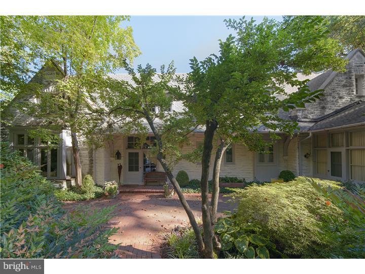 UNIQUE AND EXTRAORDINARY CARRIAGE HOME with 6 bedrooms,soaring ceilings, deep window sills and amazing architecture sits on Bryn Mawr's highest hill and was the stone stable and barn to the original Colebrook mansion. Built in 1903, this exquisite home has been expanded and modernized and is today a masterful combination of original architectural detail with state-of-the-art modern conveniences. The almost 2 acre estate, minutes from the town of Bryn Mawr, is secluded and very private and the specimen plantings, landscape architecture, charming stone and brick courtyards are a "feast for the eyes" from every window of this spectacular home. The home has a very versatile floor plan - the beautiful master suite with fireplace and new "his and hers" bathrooms on the main floor. Alternatively, there is an enchanting, very large bedroom on the second floor with a fireplace framed by two balconies and a cathedral beamed ceiling which could be used as a master bedroom as well. The hay loft has been transformed into a charming family room with built-in closets, ceiling beams, a stone fireplace with a gas stove, radiant under floor heating, reading nook and a split Dutch door which leads to the stone and brick back courtyard. This charming section of the expansive backyard includes a roofed structure which has been fitted with an outdoor gas fireplace. There is a beautiful stone pond with waterfall and atmospheric lighting. Some of the numerous upgrades include recently added 5-zone central air, 2 new high efficiency furnaces and direct access from the stunning new kitchen to the private back courtyard, and customized closets and storage spaces.. The basement has been professionally waterproofed with French drain and sump pump. The plumbing, heating and electric have all been upgraded. Extensive interior and exterior lighting has been added. The professionally landscaped grounds also feature a large, bright artist studio/office/exercise room, built by E.B. Mahoney, with hardwood floors, tray, beamed ceiling that overlooks a gorgeous heated swimming pool, and a separate in-ground hot tub. This historical home with it's amazing location and privacy, breathtaking grounds, old world charm, pristine condition and architectural details is an absolute masterpiece!!!!! Deed reflects size of property as 2.351 acres.