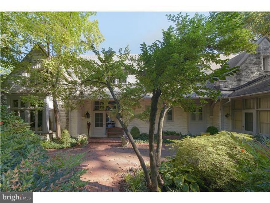 UNIQUE AND EXTRAORDINARY CARRIAGE HOME with 6 bedrooms,soaring ceilings, deep window sills and amazing architecture sits on Bryn Mawr's highest hill and was the stone stable and barn to the original Colebrook mansion. Built in 1903, this exquisite home has been expanded and modernized and is today a masterful combination of original architectural detail with state-of-the-art modern conveniences. The almost 2 acre estate, minutes from the town of Bryn Mawr, is secluded and very private and the specimen plantings, landscape architecture, charming stone and brick courtyards are a "feast for the eyes" from every window of this spectacular home. The home has a very versatile floor plan - the beautiful master suite with fireplace and new "his and hers" bathrooms on the main floor. Alternatively, there is an enchanting, very large bedroom on the second floor with a fireplace framed by two balconies and a cathedral beamed ceiling which could be used as a master bedroom as well. The hay loft has been transformed into a charming family room with built-in closets, ceiling beams, a stone fireplace with a gas stove, radiant under floor heating, reading nook and a split Dutch door which leads to the stone and brick back courtyard. This charming section of the expansive backyard includes a roofed structure which has been fitted with an outdoor gas fireplace. There is a beautiful stone pond with waterfall and atmospheric lighting. Some of the numerous upgrades include recently added 5-zone central air, 2 new high efficiency furnaces and direct access from the stunning new kitchen to the private back courtyard, and customized closets and storage spaces.. The basement has been professionally waterproofed with French drain and sump pump. The plumbing, heating and electric have all been upgraded. Extensive interior and exterior lighting has been added. The professionally landscaped grounds also feature a large, bright artist studio/office/exercise room, built by E.B. Mahoney, with hardwood floors, tray, beamed ceiling that overlooks a gorgeous heated swimming pool, and a separate in-ground hot tub. This historical home with it's amazing location and privacy, breathtaking grounds, old world charm, pristine condition and architectural details is an absolute masterpiece!!!!! Deed reflects size of property as 2.351 acres.
