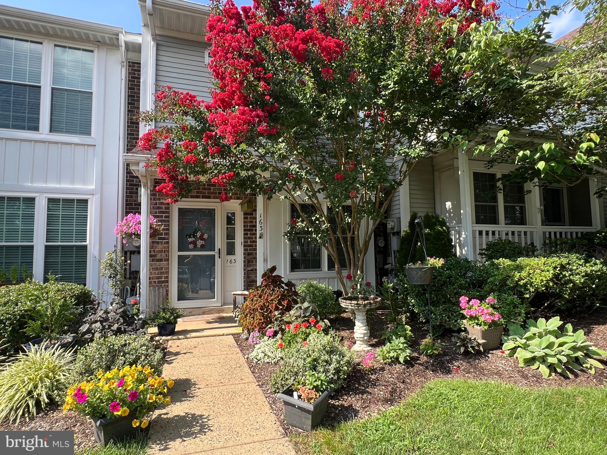 This lovingly cared-for home stands out with its vibrant, flowering yard and a long list of custom features. Inside, you'll find comfortably-chosen colors, a sun-filled kitchen with skylight and French doors leading to a back patio perfect for entertaining. Also in the spacious kitchen, a custom pet nook adds charming space for your furry friends. The second level offers two spacious bedrooms and a full bathroom. The primary bedroom features a sleek, built-in wall bed perfect for guests or maximizing living space. Off this bedroom is secondary access to the full bathroom, with shower and tub. From the upper landing, there is easy access to a 550 square foot attic, refloored to provide storage space and usability. Quietly tucked away with ample parking and walking distance from the beautiful Tyler State Park, this home blends comfort, care, and creativity in every detail. Its proximity to local shopping and location directly across the way from the community pool make it the perfect spot to settle in Newtown.