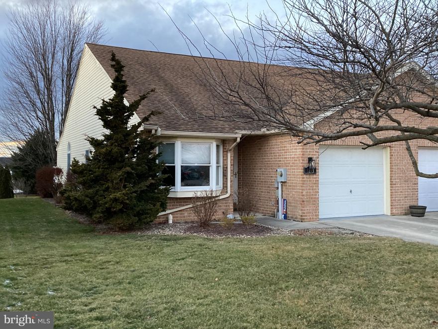This charming end-of-row townhouse in the desirable Mill Creek subdivision offers a perfect blend of comfort and modern living. Built in 1998, this ranch-style home features a warm brick and vinyl exterior, inviting you into a cozy retreat. Step inside to discover an open floor plan that seamlessly connects the living, dining, and kitchen areas, creating an ideal space for entertaining or relaxing with loved ones. The kitchen is equipped with stainless appliances, including an electric oven/range, refrigerator, and dishwasher with granite countertops and updated backsplash, making daily tasks a breeze. Nearby is the laundry with front-loading washer and dryer.  The home boasts two spacious bedrooms, each designed with comfort in mind. The primary suite features a luxurious walk-in closet and a beautifully appointed bathroom with a walk-in shower, providing a private oasis for unwinding after a long day. Natural light floods the interior through energy-efficient windows, enhancing the inviting atmosphere throughout. Laminate plank flooring adds a touch of elegance while ensuring easy maintenance. Outside, enjoy the convenience of an attached garage with a front entry and driveway parking, perfect for your vehicles and additional storage. The 0.16-acre lot offers a manageable outdoor space, ideal for gardening or enjoying a quiet moment in the fresh air. This delightful townhouse is not just a house; it's a place to call home, where comfort meets functionality in a welcoming community. Don't miss the opportunity to make it yours!  Seller is a licensed PA Realtor.