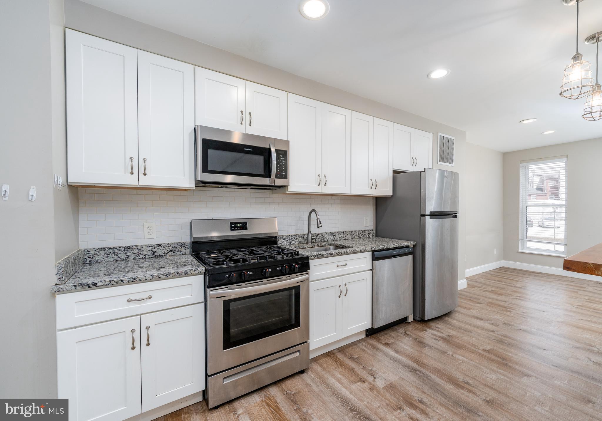 Beautifully upgraded townhouse with hardwood floors, modern kitchen, and a large private patio. Main level includes living space, laundry, and kitchen with upgraded counters, cabinets, and appliances. Upper levels offer two bedrooms and one full bath, including a spacious suite ideal for a primary bedroom or home office. Finished basement has a third bedroom, full bath, and private entrance. Steps from Harbor Point, Little Italy, and Fells Point with dining, museums, waterfront promenade, Whole Foods & 24HR CVS nearby. Available immediately. N0 PETS