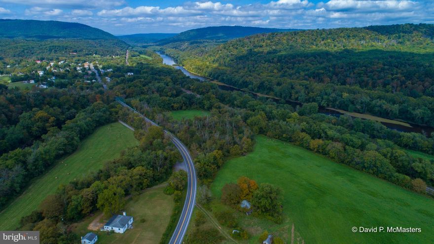SPECTACULAR 265 acres fronts on  Potomac and Cacapon Rivers and both sides of Rte 9. Part of "Panorama Overlook"; view of 3 states and 2 rivers. Rated by Nat. Geo as one of the 5 best in the East. Fronts on both sides of Power House Rd. Incl.flat pastures wooded mountainous land, river frontage.  UNRESTRICTED  A great "wilderness" camp or training center.  4 mi  to Berkeley Springs.