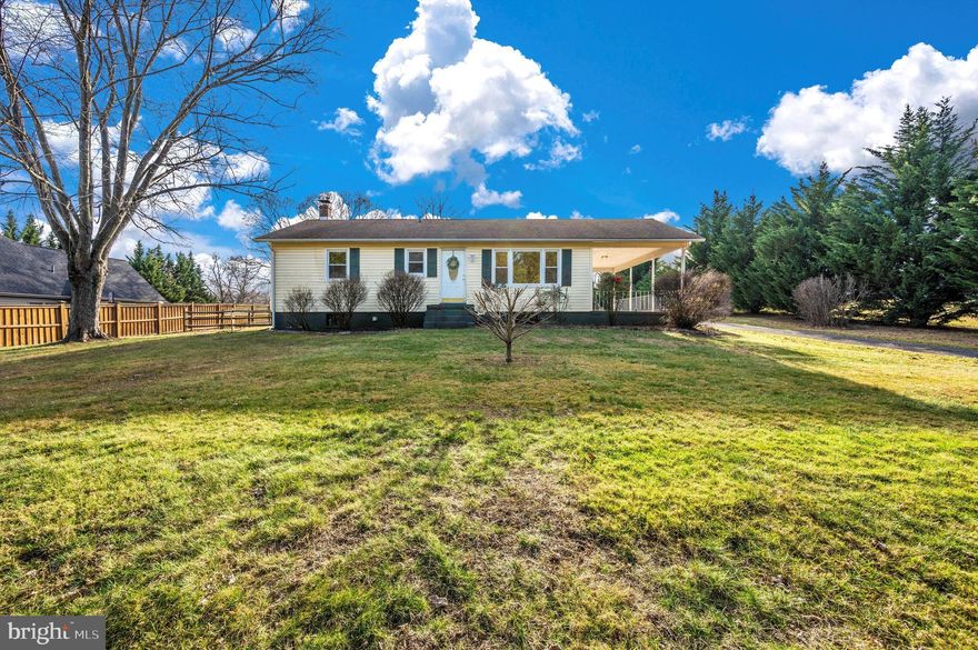Quaint two bedroom one full bath Rancher in Mount Airy on over 3 acres! Enter the main level from the attached carport into the kitchen and dining room.  Off the dining room is access to the basement and the deck in the backyard.  This level also features a large living room with a front entry door and a nice picture window, new luxury vinyl plank flooring and fresh paint throughout. The updated full hall bathroom has ceramic tile flooring, modern vanity & fixtures, and a large stall shower. Both bedrooms are spacious and the primary bedroom has its own private entrance to the backyard deck/ramp.  Downstairs is mostly finished and awaiting finishing touches (eg the ceilings.)  The basement has brand new carpet, fresh paint, a recreation room, a storage room, a huge laundry room with storage space, and two additional rooms that could be a den, office, play room, craft room, hobby room, he and she caves - let your imagination run loose! Out back, the deck does have wheelchair / scooter / walker accessibility with a ramp leading to the primary bedroom and to the rear yard. There is a fenced section in the backyard that is mostly enclosed creating a nice entertaining area.  Past this fence and into the trees awaits more of the property!  Plenty of driveway parking too.  Cozy home, huge level backyard leading down to trails, wildlife, and private peacefulness makes this a true gem in the Town of Mount Airy.