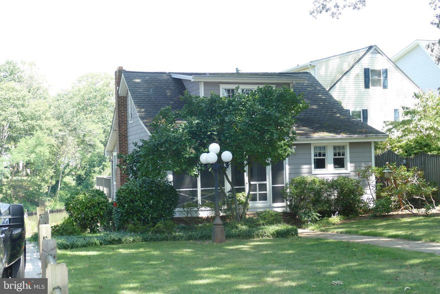 Price improvement. Seller is very motivated. Home sits on beautifully landscaped .71 acre lot on Deep Creek in Arnold, Md. across the street from Donnelly's Dockside Restaurant.  Home features a full house generator, completely renovated kitchen area, 2 large boat slips w/ boat lifts, a long private paved driveway and a huge level parking area. Home is being sold as-is and needs to be renovated.