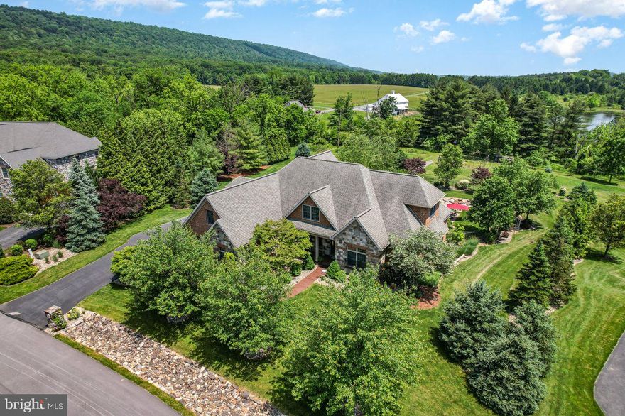 Welcome to 5043 Pellingham Circle, an exceptional custom-built residence in the prestigious Wentworth Estates. Situated in the highly regarded Cumberland Valley School District, this home combines luxury, space, and convenience. You are greeted with timeless design and gleaming hardwood floors. The formal dining room with tray ceiling, crown molding and wainscoting will be the backdrop to all of your holidays. A vaulted great room showcases built-ins, a gas fireplace and a wall of doors allowing you to let the outdoors in. Gourmet kitchen with island seating, eat in dining and a hearth room to get cozy by the  stone fireplace. Executive office. The  first-floor primary suite offers a private sanctuary with an opulent five-piece bath and an expansive walk-in closet. Upstairs, three additional spacious bedrooms each feature their own private baths, providing comfort and privacy for everyone. An airy loft space overlooks the main level, adding a touch of elegance and versatility to the home’s layout. The finished walk-out lower level is perfect for recreation and entertaining, complete with a spacious rec room, full bath, exercise room and plenty of storage space. Outdoors this property offers a private oasis on just under an acre, complete with a heated saltwater pool and mature fruit trees. This secluded, lush backyard is ideal for relaxation and hosting gatherings with friends and family. Located in a prime area, this home is just minutes from I-81, with easy access to local amenities and walking distance to the hospital. Discover the perfect blend of luxury, location, and lifestyle at 5043 Pellingham Circle!