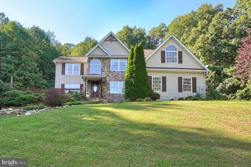 MOUNTAIN ESCAPE. Gorgeous Custom Built home (over 4,000 sq. ft.) in the Catoctin Mountains. Admire the views from this 7+ acre oasis from your wrap around porch. Surrounded by equestrian properties, very peaceful and private. Four spacious bedrooms, 3.5 baths, Primary bedroom includes a separate sitting area/optional home office with doors that close for privacy, three closets and massive bath with separate shower and jet tub and separate sinks. Main level consists of gourmet eat-in kitchen with black stainless steel appliances. Two story family room with floor to ceiling stone wood burning fireplace, wrought iron railings and custom built-in cabinetry. Dining room, living room, large laundry/mud with built in laundry chute from primary bedroom, utility sink and garage access. Den with French doors perfect for a bright sitting room/home office/virtual learning. Walkout basement consists of game room area, wooden hand carved bar, kitchenette, full bath, wood burning stove and an extra private room (currently used as a spare bedroom). Wait, not done, there is also a 24x24 outbuilding. This home is steps away from the exclusive Celebrations Cellars Winery. Minutes away from Cunningham Falls and local orchards. So private, yet minutes to downtown Frederick! This house has it all, a MUST SEE!!! Pool table and wood burning fireplace convey!