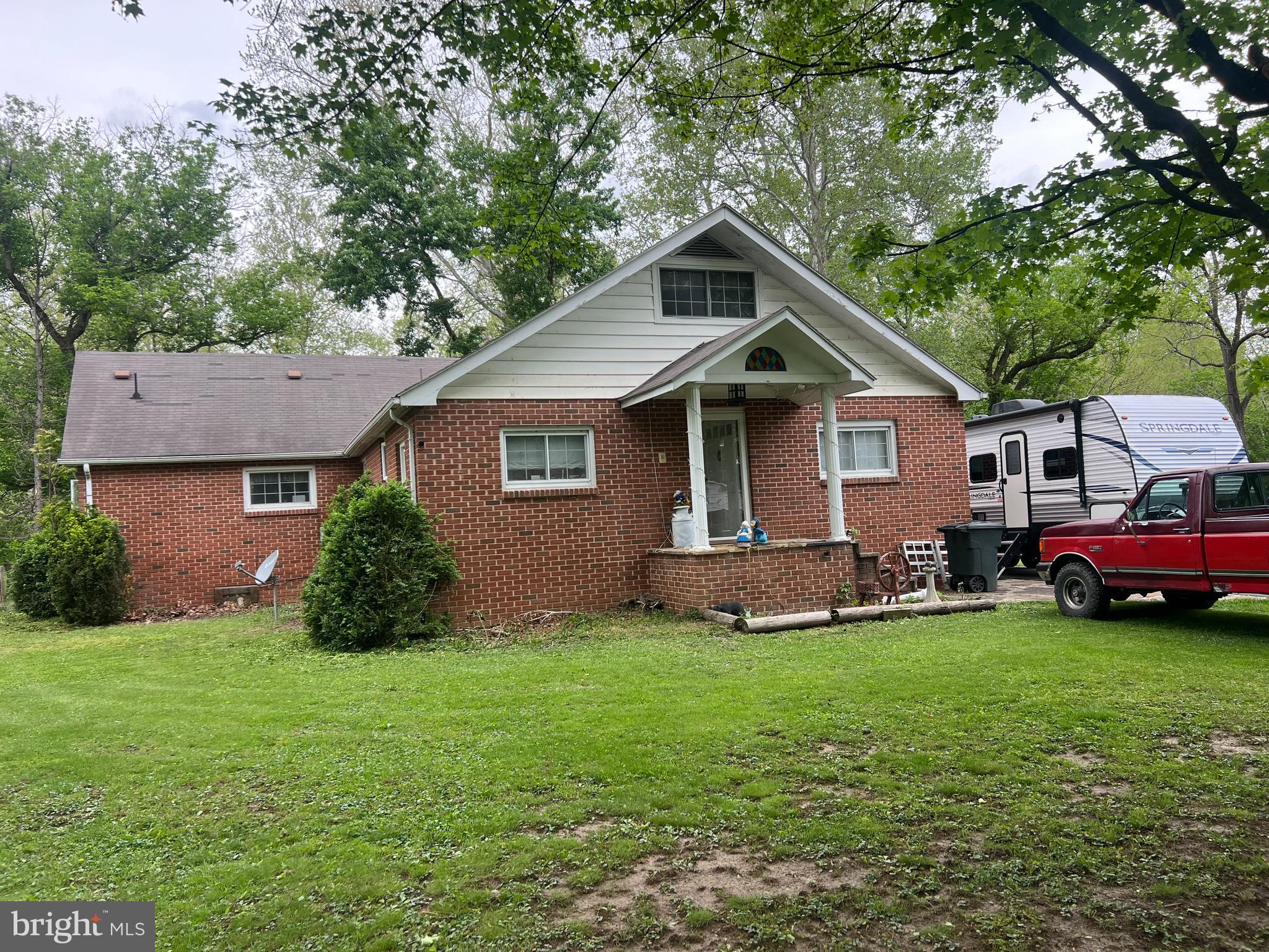 Talk about a " Diamond in the rough " that is this great 4/3 all brick home w/ detached oversize 2-car garage! This Cape Cod has a little bit of everything ! Lots of room, garage, nice level lot and DIRECT WATERFRONT on beautiful Patterson Creek ! Also comes with two seperate .9 acre lots , the one the house sits on and the one directly across the street which has a carport for additional parking and your own tennis/basketball court! This is a great home that just needs a little updating but is ready for your personal touch ! Come home after work ,shoot a few hoops before dinner and grill by the creek ! Life is good in Ft Ashby !