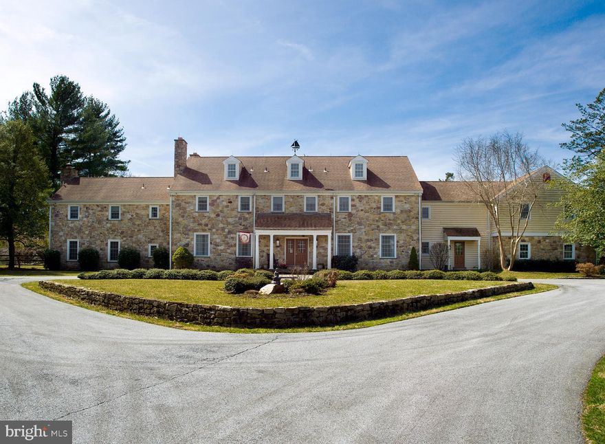 Beautiful 9,300+ square foot Farmhouse, Millcreek Farm, located in Bryn Mawr and nestled on over 13 acres of stunning views, open meadows, and elegant trees. Found at the end of a long drive, this home offers many desirable amenities including generous formal and informal spaces, beautiful millwork, hardwood floors, ample storage space, as well as pool, pool house, and tennis court. Enter this home to a center hall with spacious Living Room with fireplace sitting to the left. Steps down from the Living Room sits a handsome Office/Library with Floor to ceiling stone fireplace, exposed beams, wet bar and powder room. A generous Dining Room sits to the left of the center hall and offers built-in display cabinetry, gorgeous millwork, and door to the Kitchen. Enjoy plenty of desirable amenities in this Chef s kitchen including plenty of prep space with Brazilian Blue granite counters and center island, as well as high quality appliances such as Sub Zero Refrigeration, Gaggenau cooktop, oven, and warming drawer, and Miele dishwasher. A breakfast area sits adjacent to the kitchen, with sliding doors leading to an impressive and expansive sunroom offering stunning views of the rear property. A hall lading from the Kitchen provides access to a second powder room, concealed second stair, laundry, and access to the home s 4 car garage. Across the Kitchen and through the center Hall sits a cozy Family Room with built-in shelving and cabinetry, brick surround fireplace and wainscoting. Ascend a spiral stair to the second floor and to the right through double doors sits the Master Bedroom Suite with His and Her Walk-In closets, master bathroom with standing shower and jetted tub, and half bath with sauna. Following a long hall, find two family or guest bedrooms with private, ensuite bathrooms and two bedrooms with a shared bath. Further down the hall finds linen storage, walk-in cedar closet, secondary laundry room, and two additional bedrooms, one currently purposed as a playroom while the other as an office, both sharing a bathroom. A partially finished third level provides additional storage space or the opportunity to add additional finished space to the home. Outside enjoy a tennis court, deck with hot tub, or an oversized pool as well as a pool house with open sitting or entertaining space, kitchenette, and two separate changing rooms each with shower. A truly beautiful estate waiting for its next buyer.