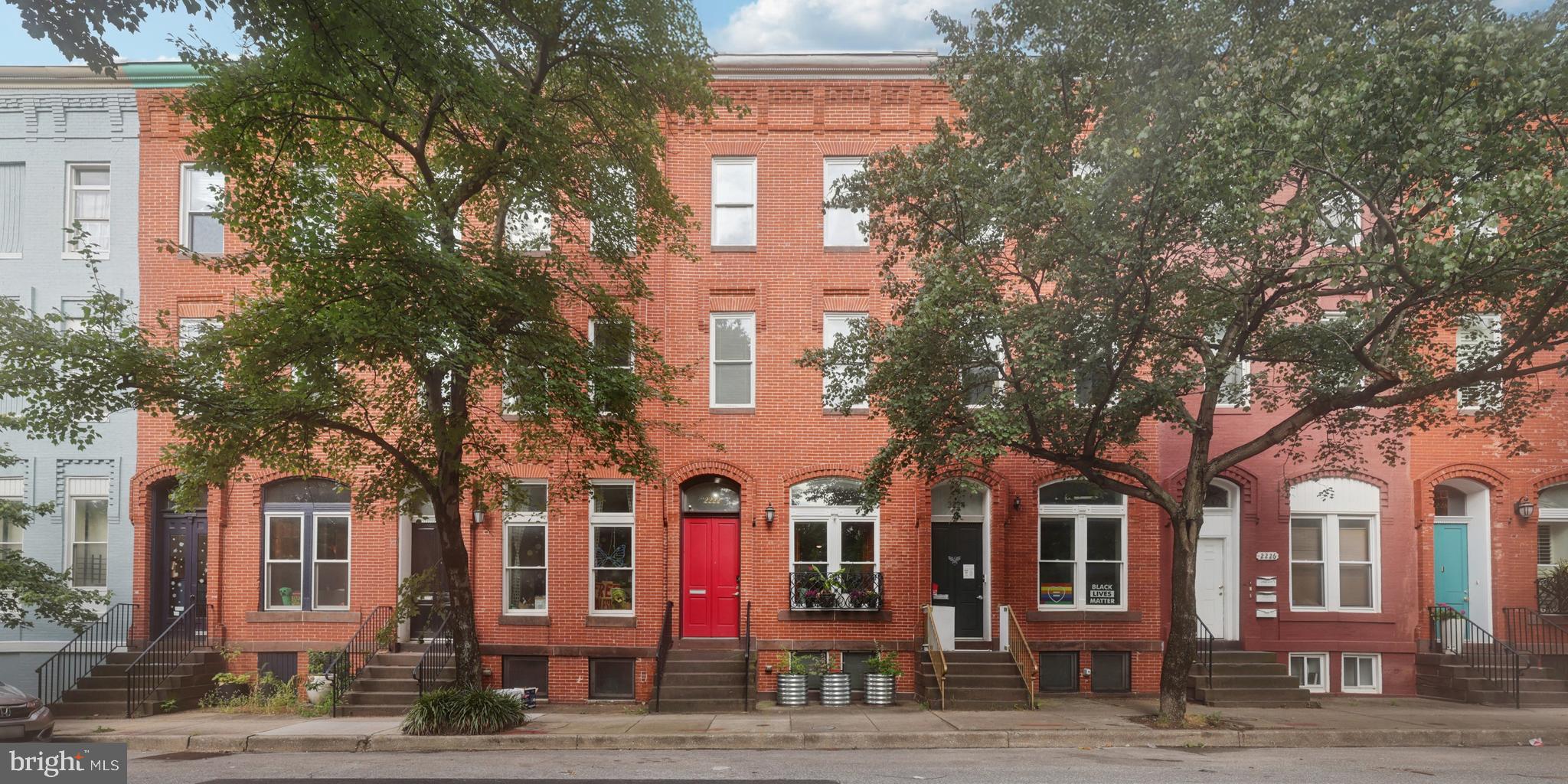 Discover timeless charm and thoughtful updates in this traditional-style interior rowhome located in the heart of Baltimore. Featuring soaring 9’+ ceilings, hardwood and tile/brick flooring, and central A/C, this home blends classic character with modern comfort. Enjoy views of a city-owned greenspace that spans the entire block—an ideal setting for relaxation or recreation.
The home was fully renovated and rebuilt in 2012, incorporating many energy-efficient features for modern living. Two HVAC systems with dual zones ensure year-round comfort. The first floor is bathed in natural light thanks to dramatic floor-to-ceiling windows, while the kitchen offers granite counters, a spacious island, and upgraded finishes. Step out to the composite covered deck overlooking the garden patio—easily reimagined as a parking pad for added convenience.
The top floor has been creatively transformed with a custom-built wall and hidden bookcase door, creating a flexible space perfect for a private office or an additional bedroom. Recent interior enhancements include re-wallpapering the entry half wall, refreshing the half bath with updated flooring, wallpaper, and lighting, adding a new tile backsplash, pendant lighting, and a hanging pot rack in the kitchen, plus carpet tile flooring in the basement and updated lighting in the primary bedroom.
Outdoor enthusiasts will appreciate the urban patio garden, complete with 8 raised beds, 3 arch trellises, and a variety of perennials in both the front and rear yards—designed to return year after year with proper care. This home offers a unique blend of historic appeal, modern efficiency, and stylish upgrades in a vibrant urban setting.