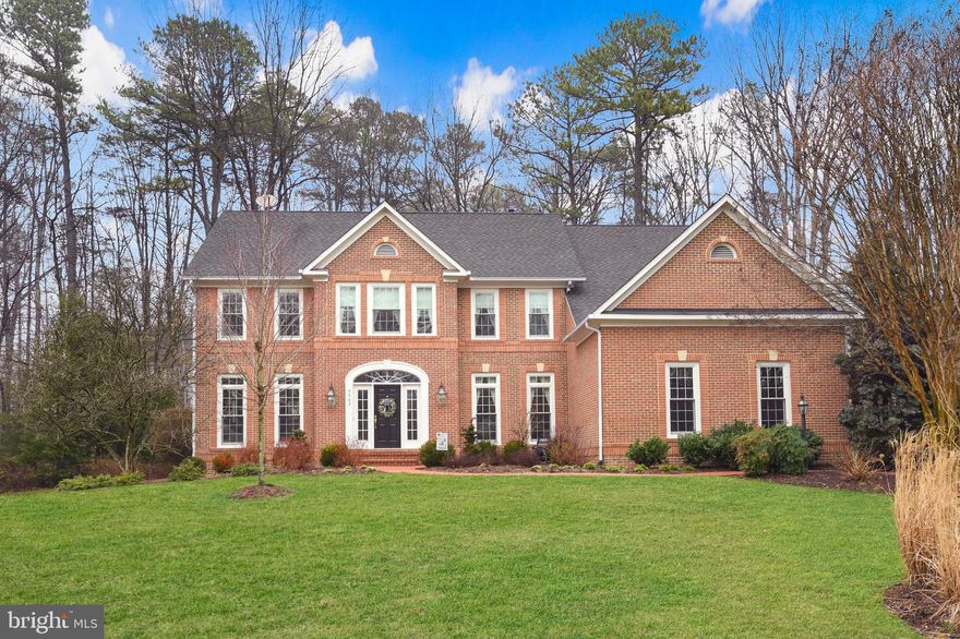 Discover the epitome of luxurious living in this distinguished custom-built Stanley Martin home, nestled within the highly sought-after Edgewater community. With approximately 5,800 square feet of meticulously designed living space, this residence has been thoughtfully crafted for a seamless blend of elegance and functionality. Newly remodeled with over $250,000 in upgrades! Follow the brick paver walkway to a grand, light-filled foyer, setting the tone for the sophistication that awaits within. The brand-new professional chef’s kitchen has over $107,000 in upgrades and features luxurious white ceiling-high cabinetry with under cabinet lighting, high-end stainless-steel appliances, granite counters, tile backsplash, walnut center island with gas cooktop and a butler’s pantry with beverage fridge. Enjoy relaxing in the family room with a dramatic 2 story ceiling, gas fireplace, and wall of windows overlooking the wooded backyard. Step outside to your very own backyard oasis, complete with an expansive slate and stone patio and a brand new built-in hot tub. Immerse yourself in nature surrounded by mature hardwood trees and beautiful landscaping for total privacy. The main level also features a private study, half bath, laundry room and elegant living and dining rooms perfect for entertaining guests. The upper level boasts a luxurious Primary Suite with dual walk-in closets and a spa-like bath that recently underwent a $30,000 renovation. The primary bath features a furniture-quality vanity built-in with quartz counters, dual sinks and vanity mirrors that provide the convenience of extra storage and plug outlets to keep your items out of sight. It also features heated flooring and heated towel rack, a soaking tub, shower with glass door and dual shower heads and custom tile throughout.  The versatile 2nd bedroom is uniquely accompanied by its own attached bonus room and stunning remodeled private bath, offering endless possibilities. 2 additional bedrooms sharing a jack-and-jill bath complete the upper level. Incredible lower level features a spacious living and gaming area with a stone gas fireplace and full wet bar, ideal for entertaining family and friends. Real 5th bedroom and full bath provide flexibility and convenience.  Brand new HVAC and energy-efficient windows throughout have proven to provide lower utility bills. Custom three-car garage is designed to house a boat, and an oversized newly paved driveway provides ample parking for guests. Conveniently located just seconds to Fairfax County Parkway and minutes to Burke Lake Park, top-notch schools and shopping. This grand home seamlessly combines convenience and luxury, making it a rare gem within the Edgewater community. Schedule your private tour today to experience the unparalleled elegance and comfort that awaits.