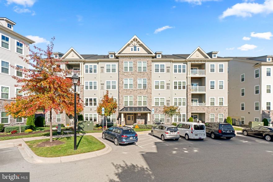 Spacious, energy-efficient, and elevator-accessible, this condominium offers 2 bedrooms, 2 full bathrooms, and 1,437 sqft of living space in the sought-after Waverly Mews 55+ community in Waverly Woods West, Marriottsville. The interior begins with the extended foyer leading to the open-concept layout adorned with recessed lighting and high vaulted ceilings throughout the living room boasting a gas fireplace, wood louver blinds, and private balcony access, the dining area with glass slider balcony access, and the eat-in kitchen. The space also includes a hidden laundry closet and 2 bedrooms each with a private bathroom.  The upper level boasts a stunning loft perfect for an additional lounge space or office. The bright chef’s kitchen features 42” raised panel cabinetry, a gas stove, a tile backsplash, a pantry, stainless steel appliances, hardwood floors, and an island with an elevated breakfast bar. The owner’s suite includes a walk-in closet, a standard-sized closet, and a private bath with an oversized step-in shower and dual vanity. The community offers a prime location with golf course access, a clubhouse, a fitness center, an outdoor pool, walking paths, and more!