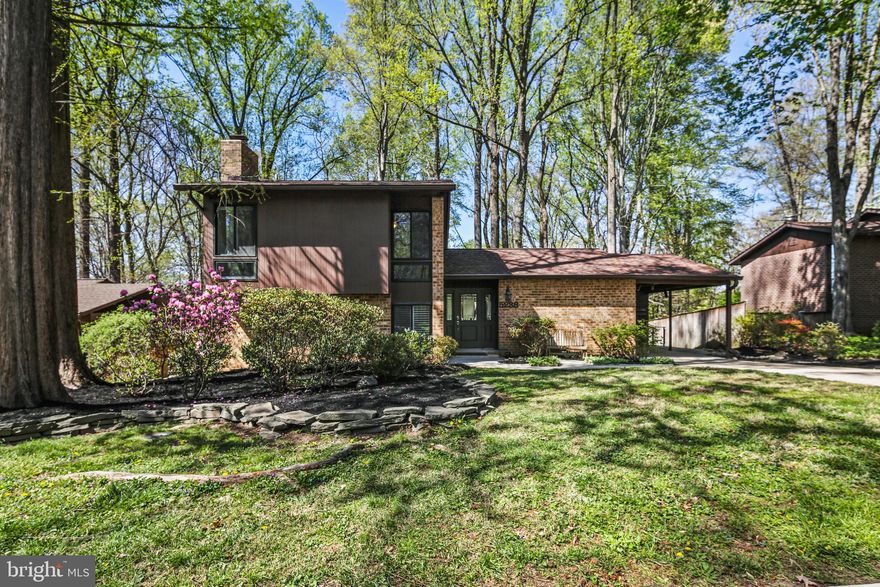 OFFER DEADLINE: 10 AM, SATURDAY, MAY 3RD. 
This light filled split level is tucked away in a private setting surrounded by mature trees with soothing wooded views from just about every room! As you head up the driveway and into the carport, you’ll appreciate the covered parking—especially on those rainy or snowy days. Head inside and into the bright and open main level, where beautiful hardwood floors extend throughout. The open layout keeps everyone connected, whether you're cooking, relaxing, or entertaining. The renovated kitchen is gorgeous with white cabinets, a custom tile backsplash, sparkling granite counters, and a huge island with seating. Stainless steel appliances, a pantry, and a coat closet round it all out. There’s room to gather around the island or sit down for a meal in the adjacent dining area. When the weather’s nice, open the sliding door and head out to the deck and patio, complete with exterior lighting. Enjoy dinner under the trees or wind down after a long day with your favorite drink. Upstairs, the owner’s suite truly is a private retreat. With high ceilings and windows on three sides, it’s flooded with natural light by day, and the custom blinds (added in 2014) provide privacy when you want it. The suite also includes a spacious walk-in closet and a spa-like bath with a custom double vanity, gorgeous tile, and a large shower. There's even an oversized bonus sitting area currently being used as a home office. Down the hall are three more bedrooms and an updated full bath. Just below the main level, you’ll find even more living space. The cozy family room features extra-long windows with custom shutters so you can adjust the light and privacy. Built-in shelves add charm, and a full bath (renovated in 2014) sits just beyond. You’ll also find the laundry area and a large rec room with a slider leading to the backyard. At the back of the home is a super flexible space with a private entrance—perfect for a hobby room, home gym, or bonus guest space. Welcome home!