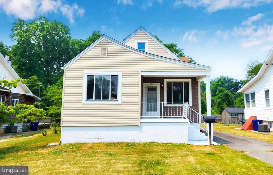 CONTEMPORARY CAPE COD WITH TONS OF SPACE IN THE HEART OF CHARMING LAURAVILLE! This stylishly appointed home features upgraded finishes and a modern color palette suitable for any home buyer. As you enter the front door, satin finished wood floors are accentuated with natural light and a fabulous stained glass window glows with all the artistry evident in this quintessential Baltimore community. An expansive open concept floorplan provides a variety of options for furniture layout and makes living here a breeze. Two sizable bedrooms flank either side of the living room and both bedrooms feature especially large and sunny windows, allowing you to enjoy the private wooded setting out back. A very spacious full bathroom is also on the main level and is complete with a sophisticated tile shower and modern vanity. For those that enjoy spending time in the kitchen, this home has just what you're looking for: tons of space to prepare food as well as space to add a table and chairs, a bar or even additional cabinets.  Directly off of the kitchen is a large deck, perfect for grilling or to relax and enjoy fresh air. The second floor showcases original wood flooring and a balcony that is surrounded by a lush canopy of trees.  Downstairs, a huge basement featuring high ceilings has endless potential yet also provides the added convenience of an updated full bathroom. As unique as this home is, the appeal doesn't stop there! This particular house sits on almost 1 acre of private, wooded property that lends to a suburban feel without having to leave the allure of city living. Convenient to dining, local area hangouts, shopping and transportation.