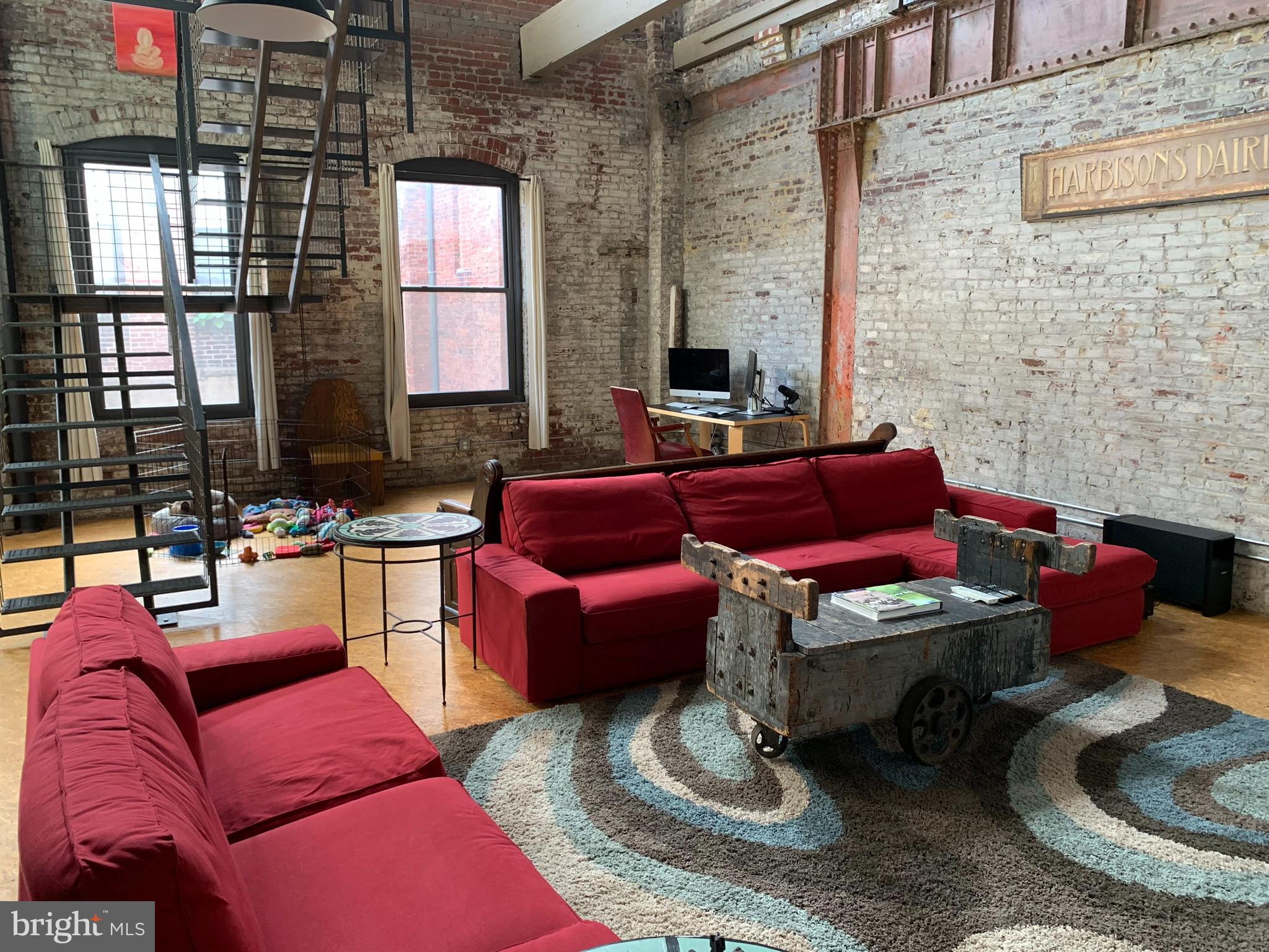 Be a part of East Kensington's unique community at Milk Depot Lofts. Centered around a lush courtyard and framed by custom fabricated steel staircases and balconies, Milk Depot is an adaptive reuse of the Harbison Dairy and a labor of love by Philadelphia's own COVER LLC design/build firm. The industrial character of the building is central to its design: open floor plans, exposed brick walls and duct work, soaring ceilings, wood trusses, and large windows with abundant natural light. This bi-level unit with courtyard and Center City views has interior and exterior stairs to access the unit to Amber and Dreer Streets, respectively. There are no walled off bedrooms so you have the choice (and space) to create bedrooms or leave it open to enjoy the visual of this architecturally noteworthy space. High efficiency mechanicals, insulated windows/doors, 1-2 more years on the Tax Abatement and low condo fees make this an affordable home. Central air, in-unit washer/dryer, huge walk-in closet, intercom to let in your guests in from your phone, basement storage and a 5-minute walk to the Berks Station El stop and many area favorites round out this unique and coveted loft space in East Kensington.